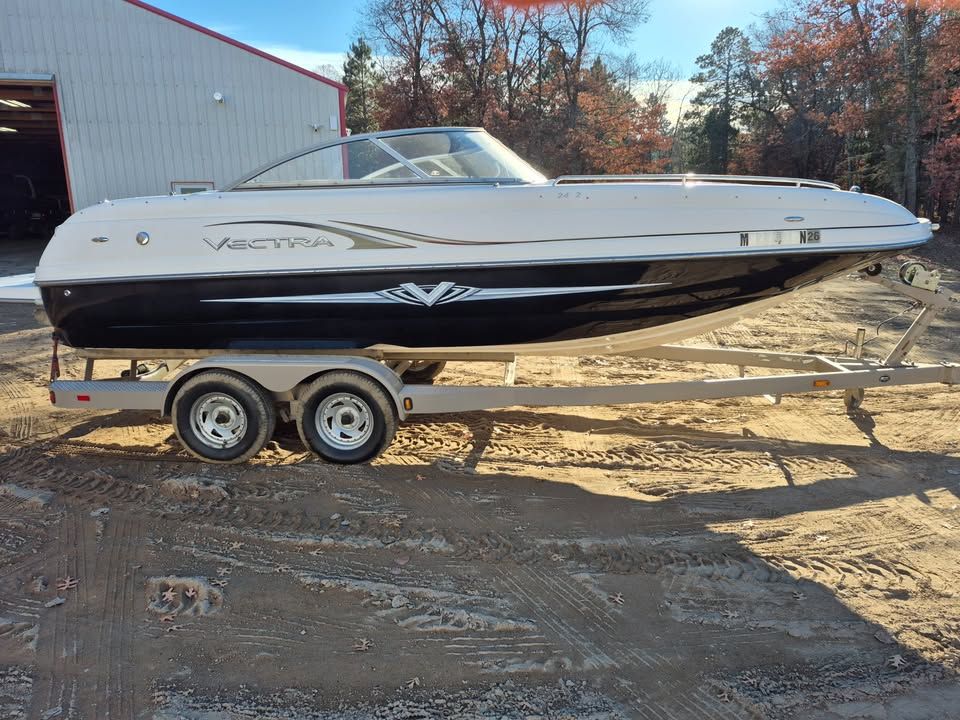 2008 Vectra 2402 IO boat on trailer outdoors.
