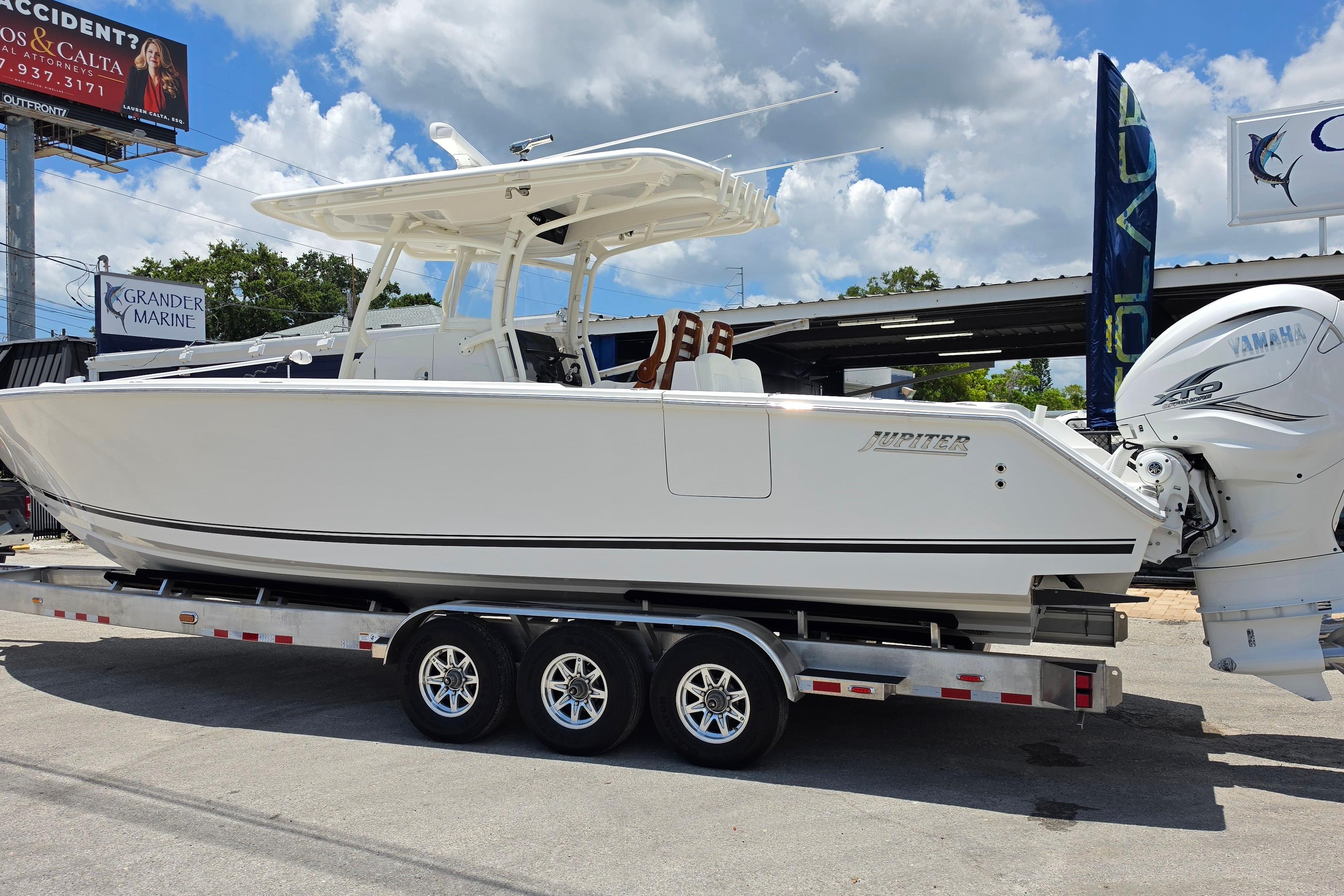 2020 Jupiter 34 HFS boat on trailer with Yamaha engines, displayed outdoors.
