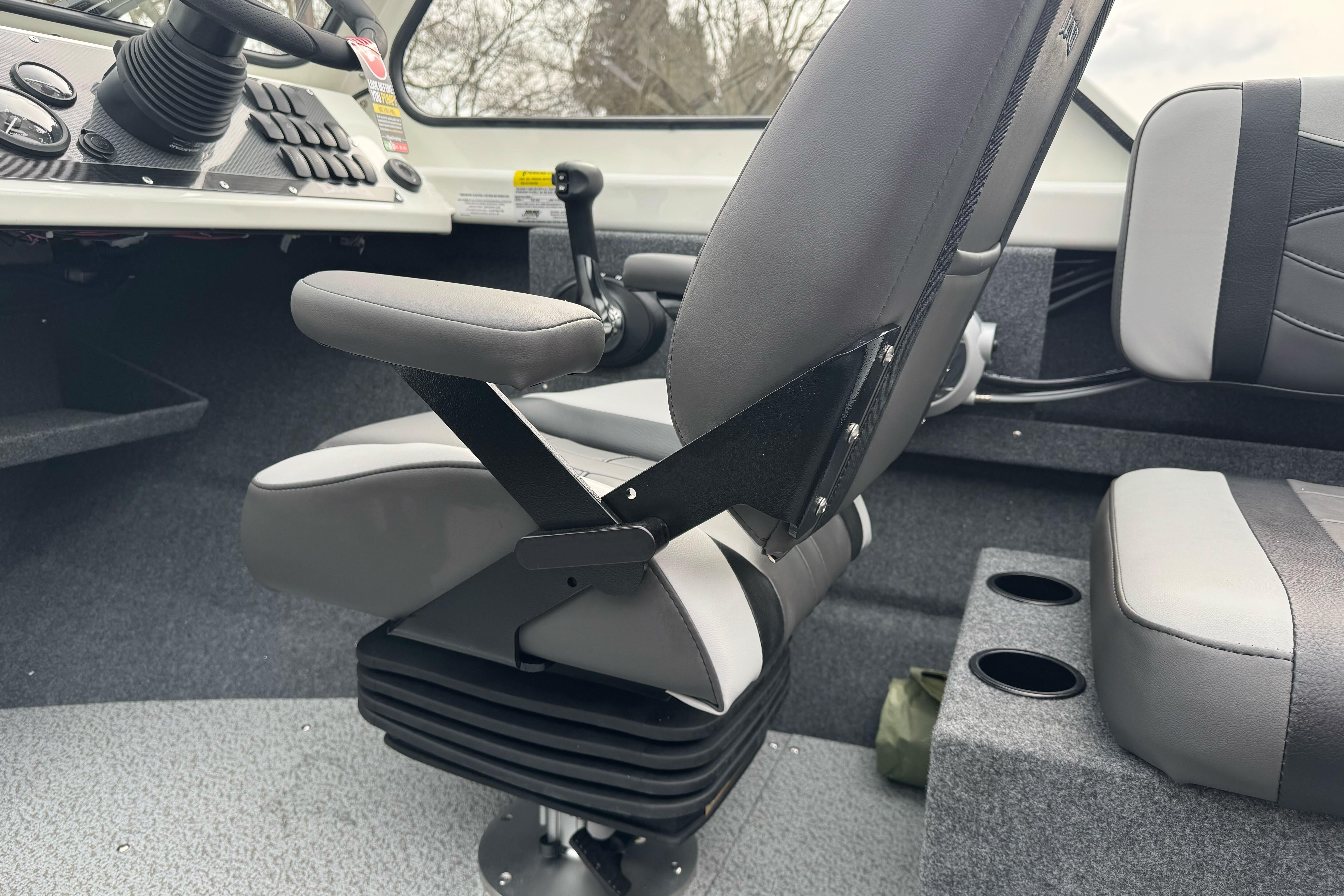 Interior of 2026 Lund 185 Heavy Gauge boat with gray seating and control panel.