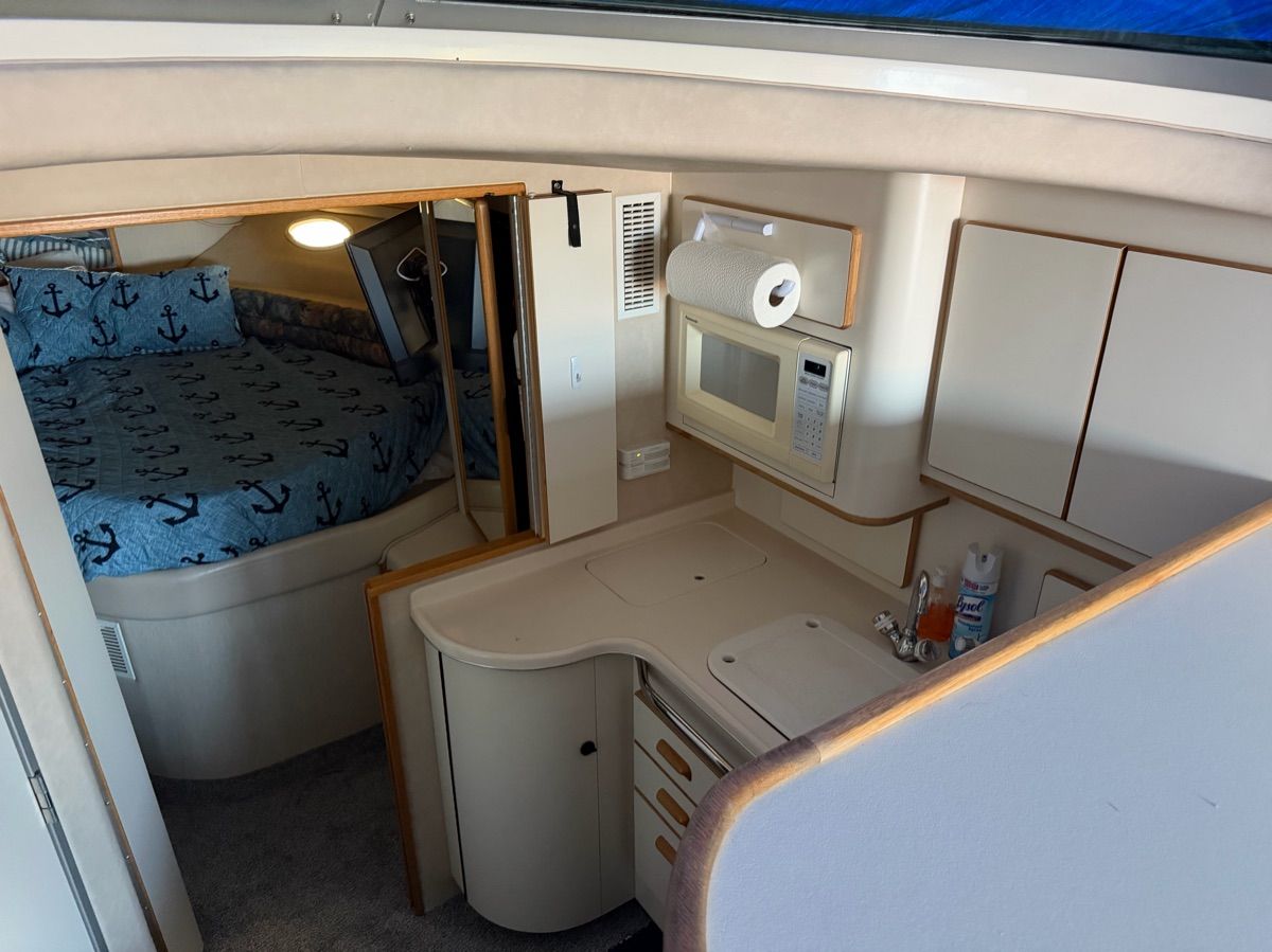 Interior of the 1996 Sea Ray 370 Sedan Bridge with kitchen and sleeping area.