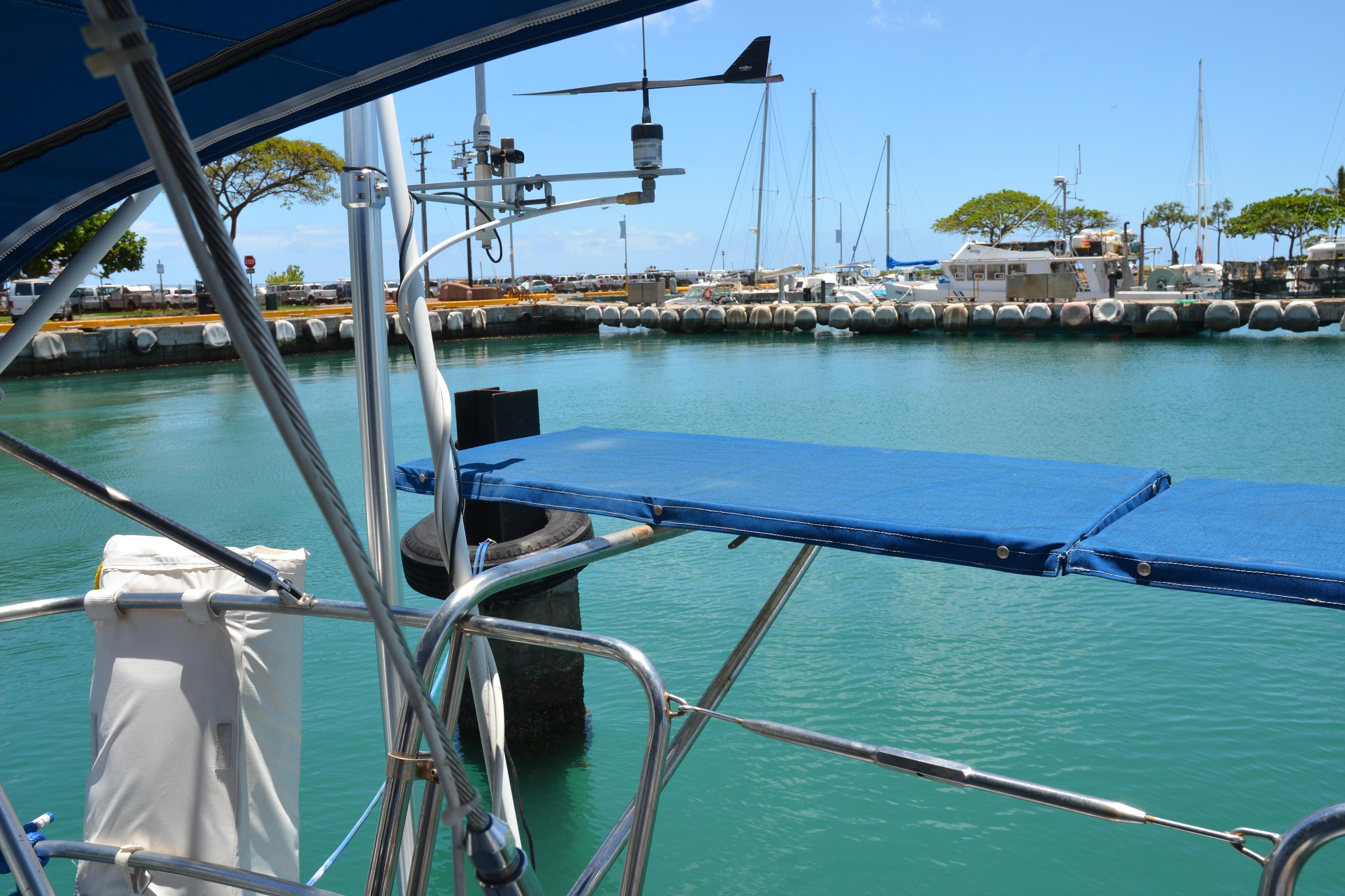 Sailboat docked in marina, Norseman 400, 1987 model, with clear blue water and sky.