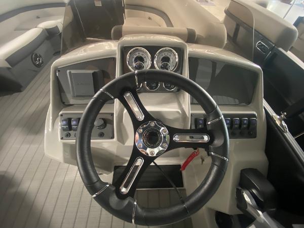 2024 Starcraft EXS 1 boat dashboard with steering wheel and control panel.