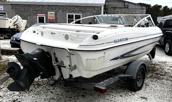 2005 Glastron MX boat on trailer, white exterior, parked outdoors.