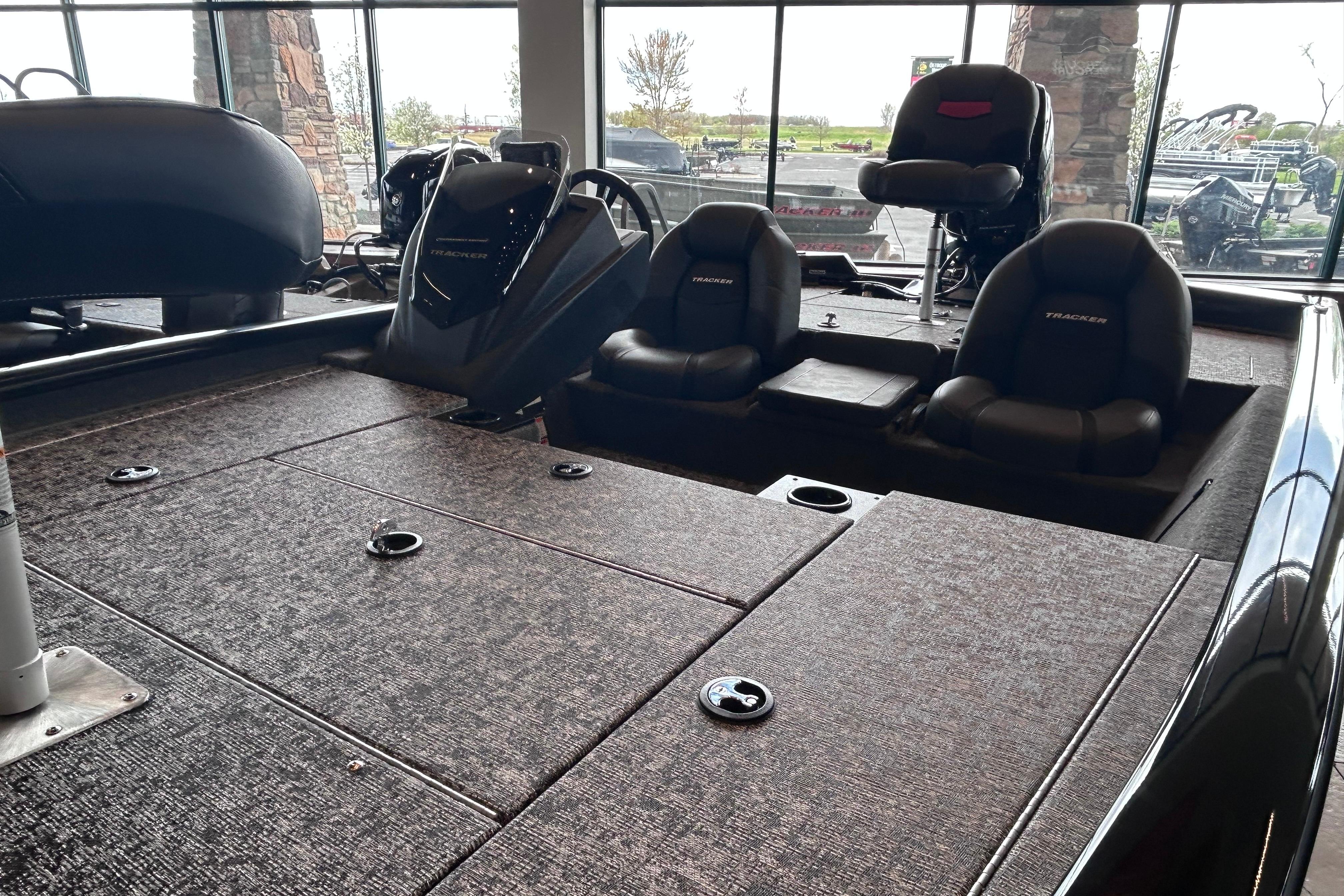 2026 Tracker Pro Team 195 boat interior with seating and carpeted deck.