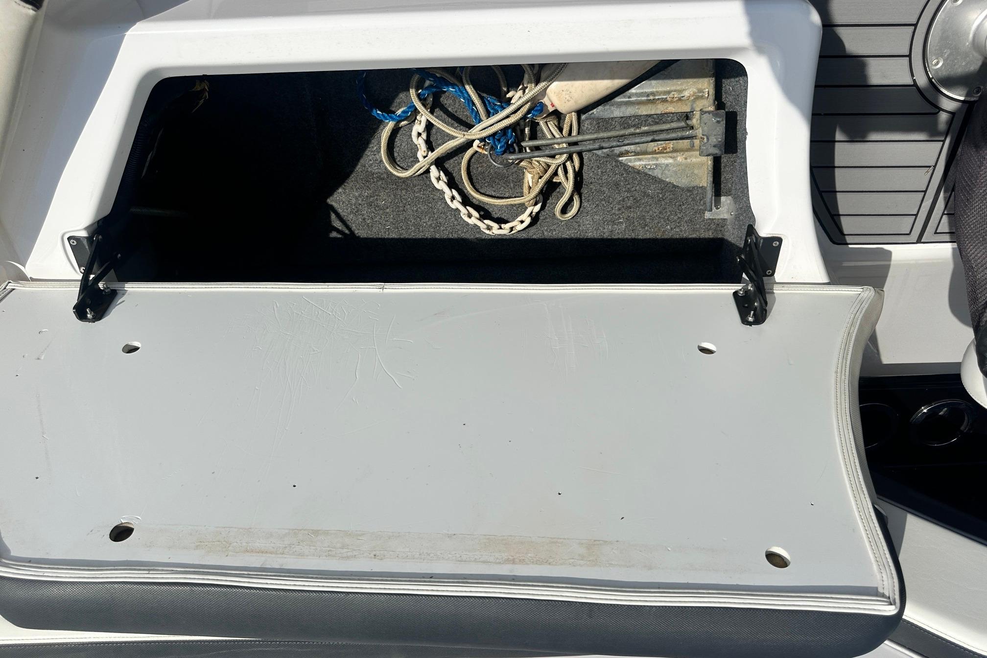 Open storage compartment on 2016 Yamaha 242 Limited S boat, containing ropes and anchor.