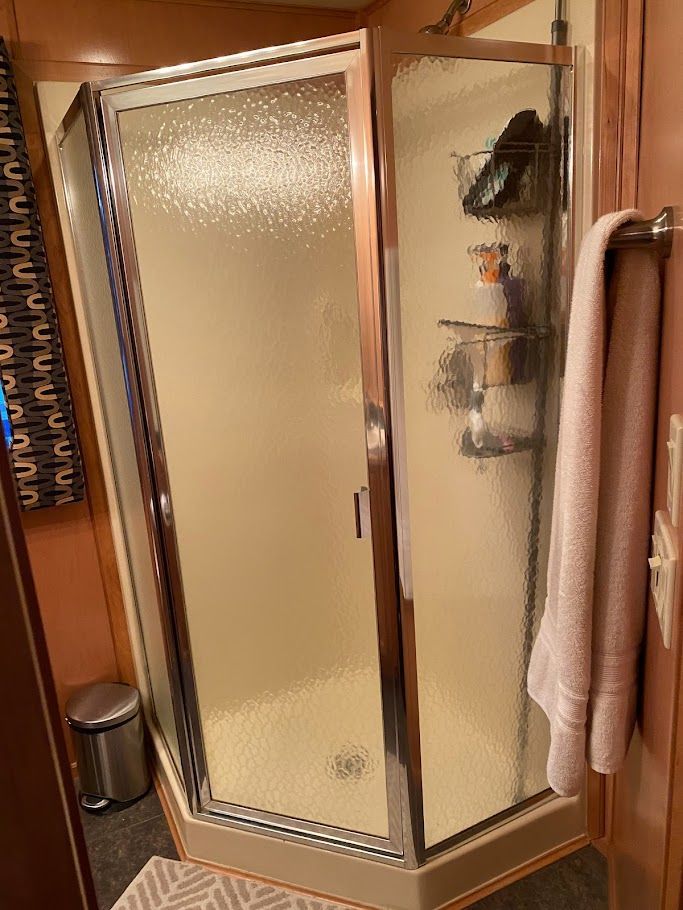 Corner shower in a 2006 Summersun Houseboats 16x68 model.