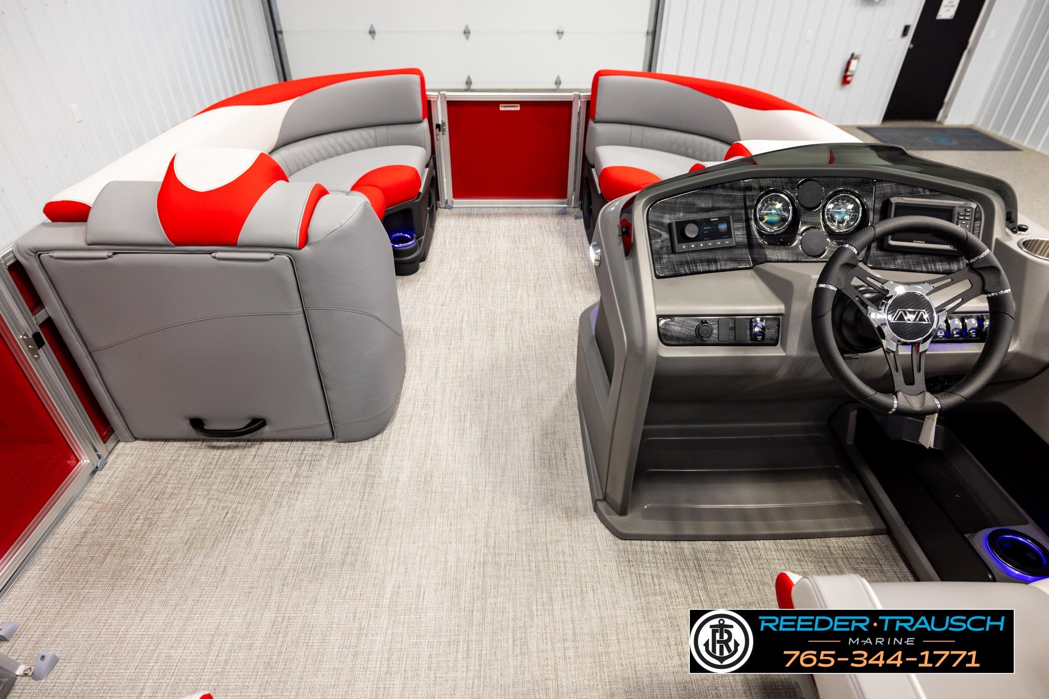Interior of 2026 Avalon LSZ QL pontoon boat with modern dashboard and red-gray seating.