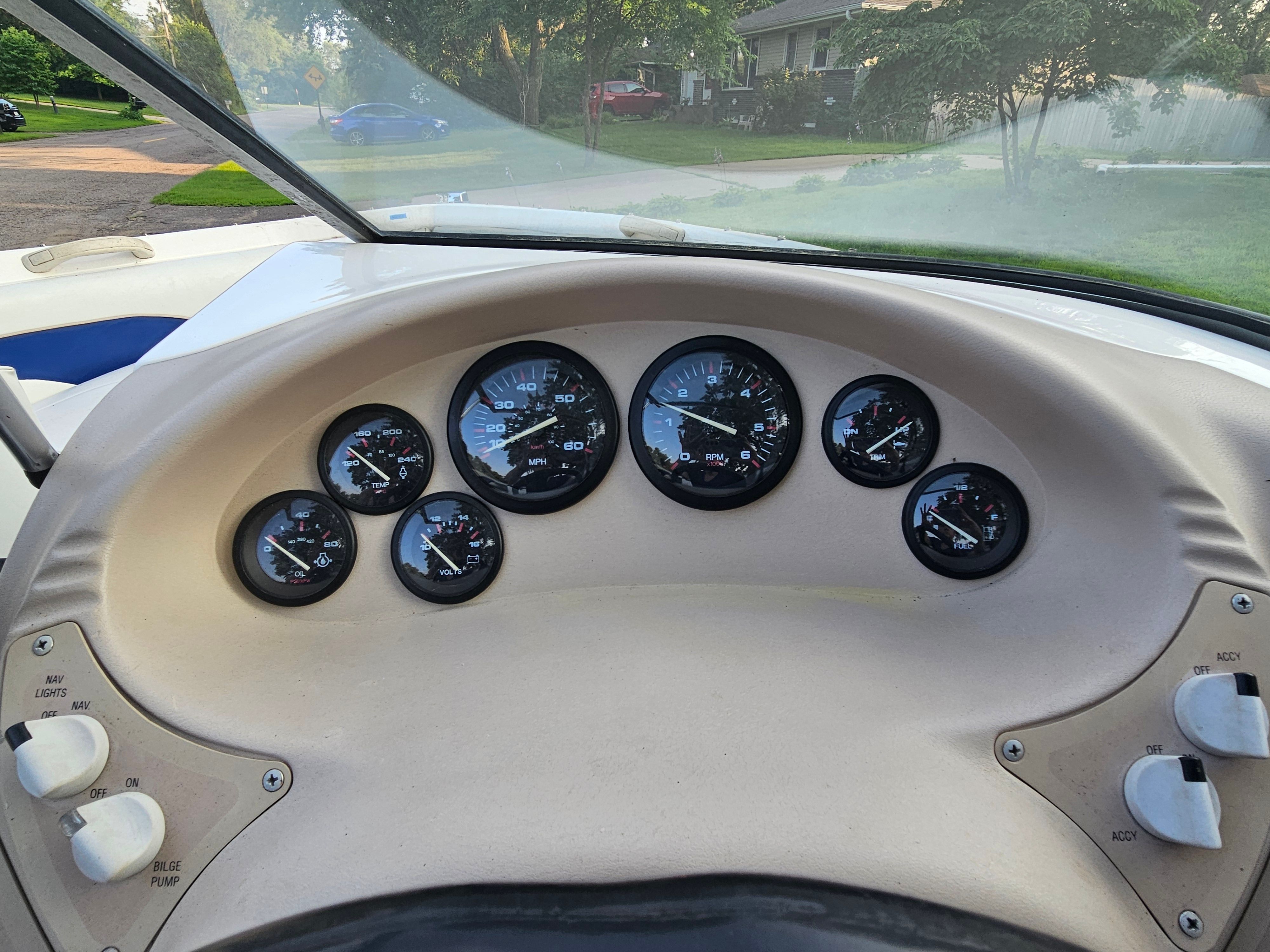 Dashboard of a 1996 Wellcraft Excel with multiple gauges and control knobs.