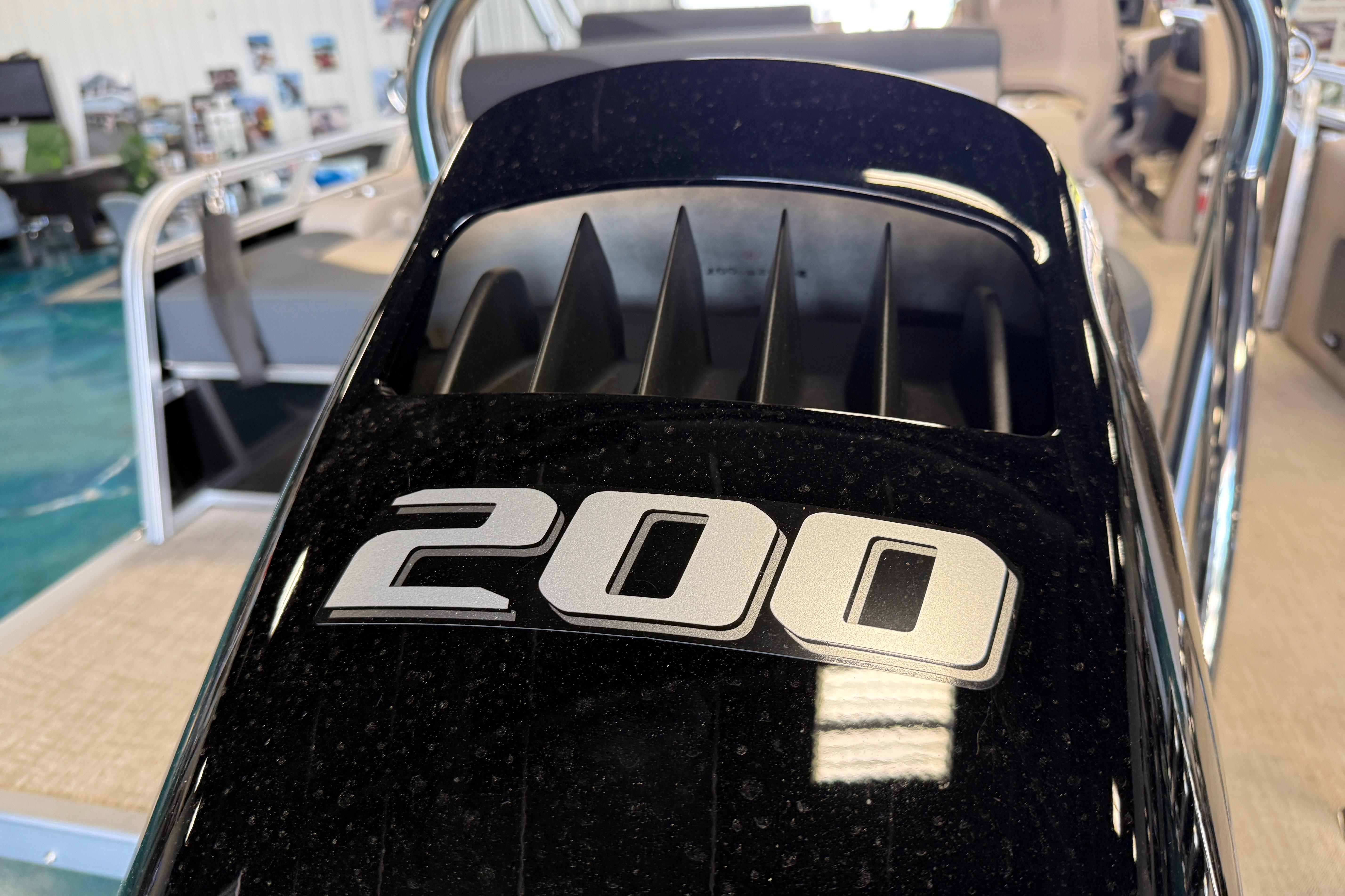 Close-up of 2026 Tahoe Pontoon LTZ Entertainer engine with "200" label.