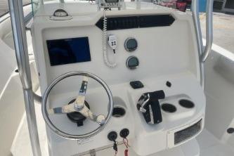 2023 Sailfish 242 CC boat dashboard with steering wheel, controls, and navigation instruments.