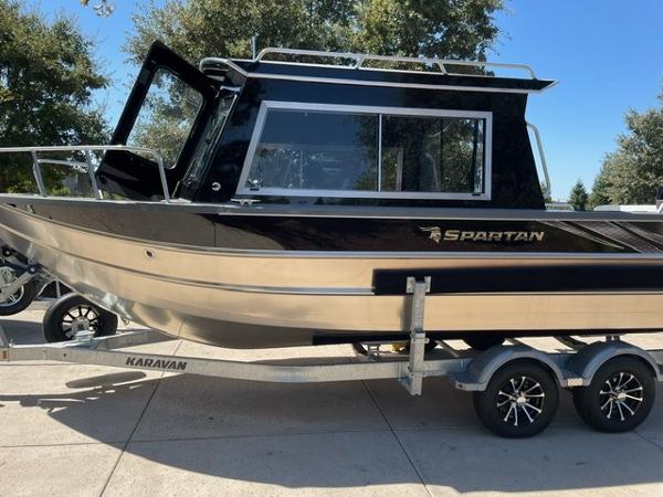 2024 Spartan 220 Maximus boat on Karavan trailer, parked outdoors.