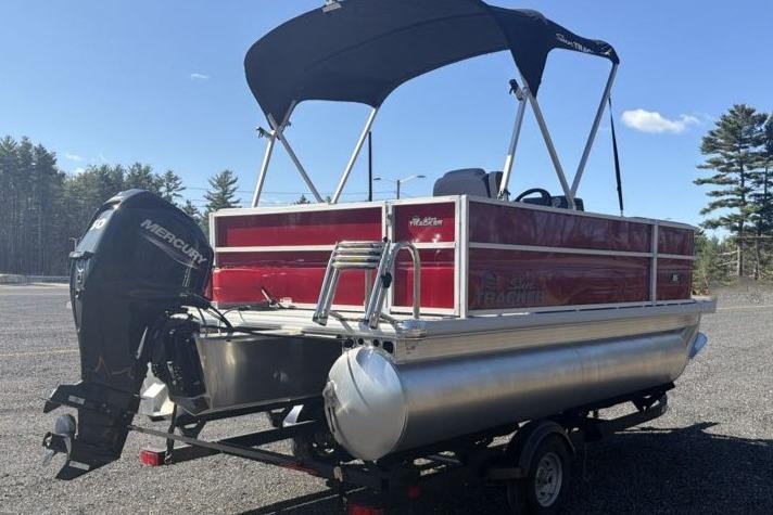 2026 Sun Tracker Party Barge 16 DLX pontoon boat with canopy and Mercury outboard motor.