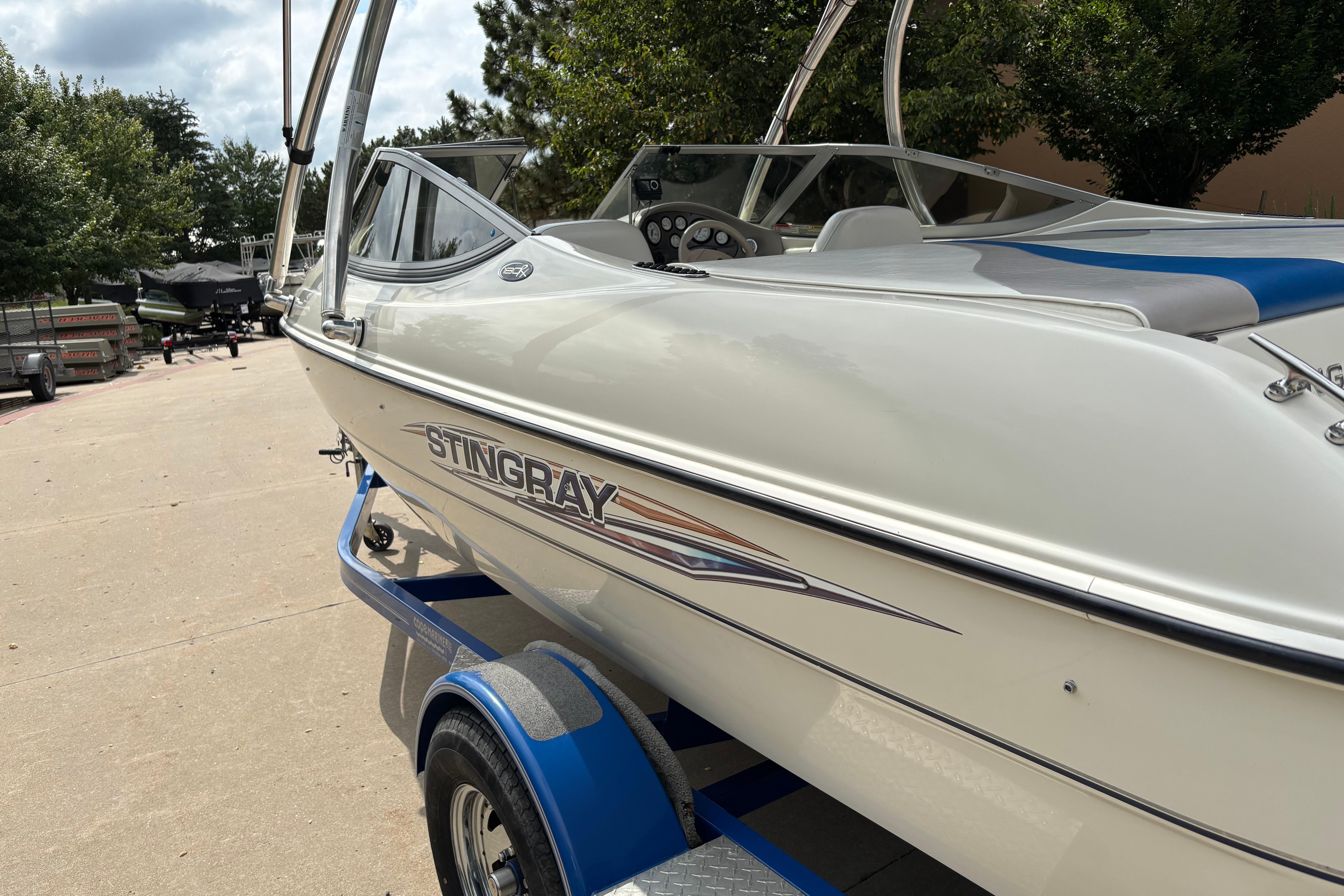 2007 Stingray 180 RX boat on trailer, white exterior, parked outdoors.