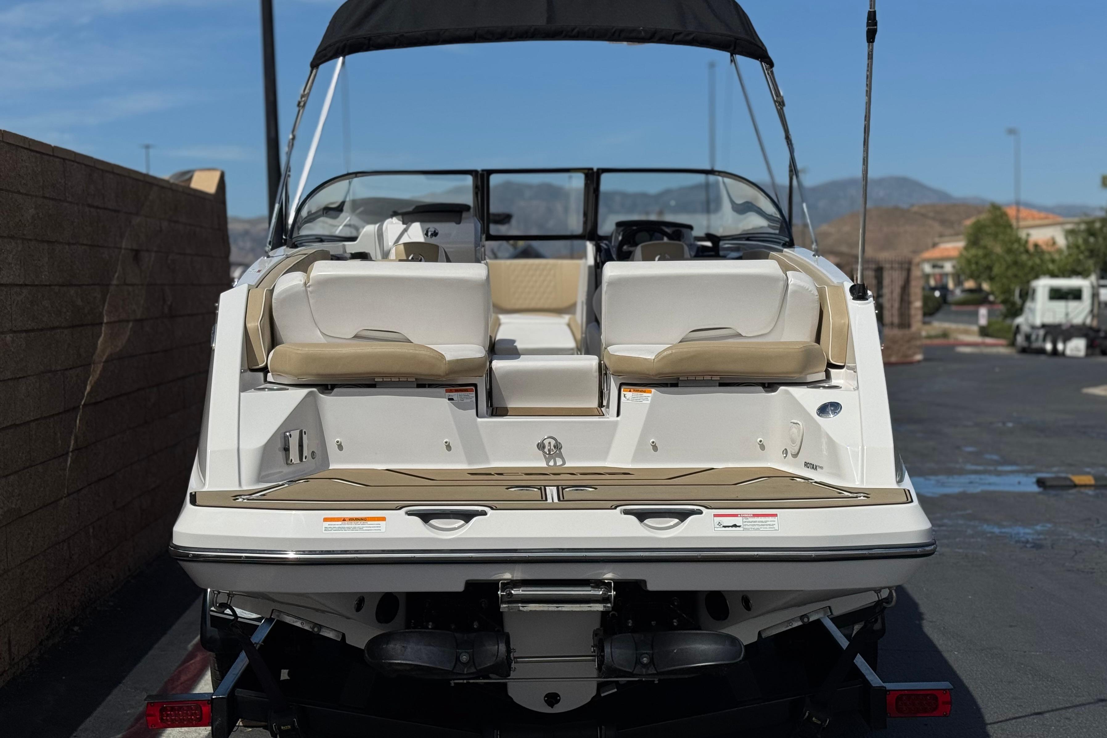 2017 Scarab 255 H.O. Platinum boat, rear view, parked outdoors.