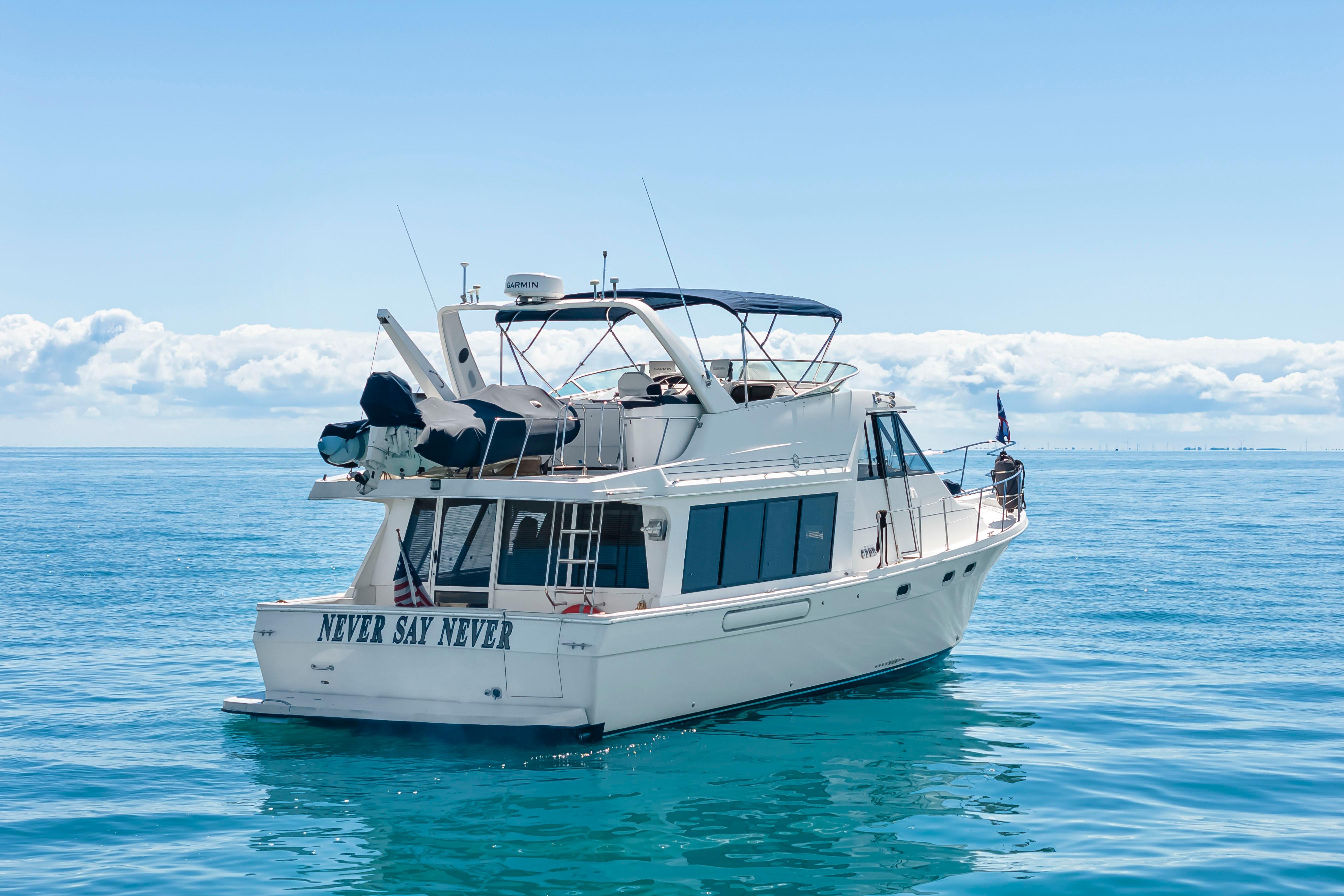 1997 Bayliner 4788 Pilot House Motoryacht on calm blue ocean waters.