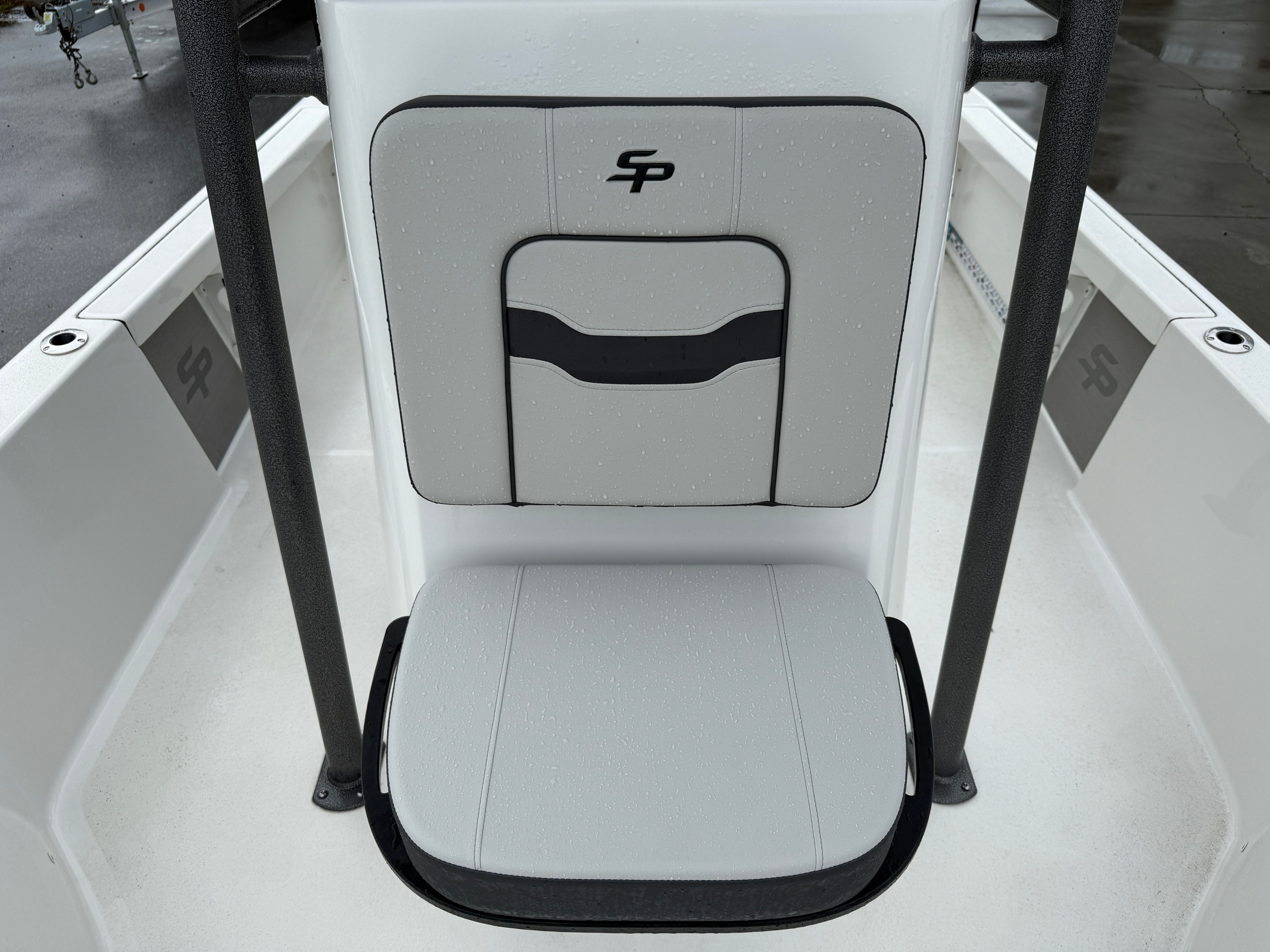 Rear view of a Sea Pro 230 DLX boat seat with gray upholstery and black logo.