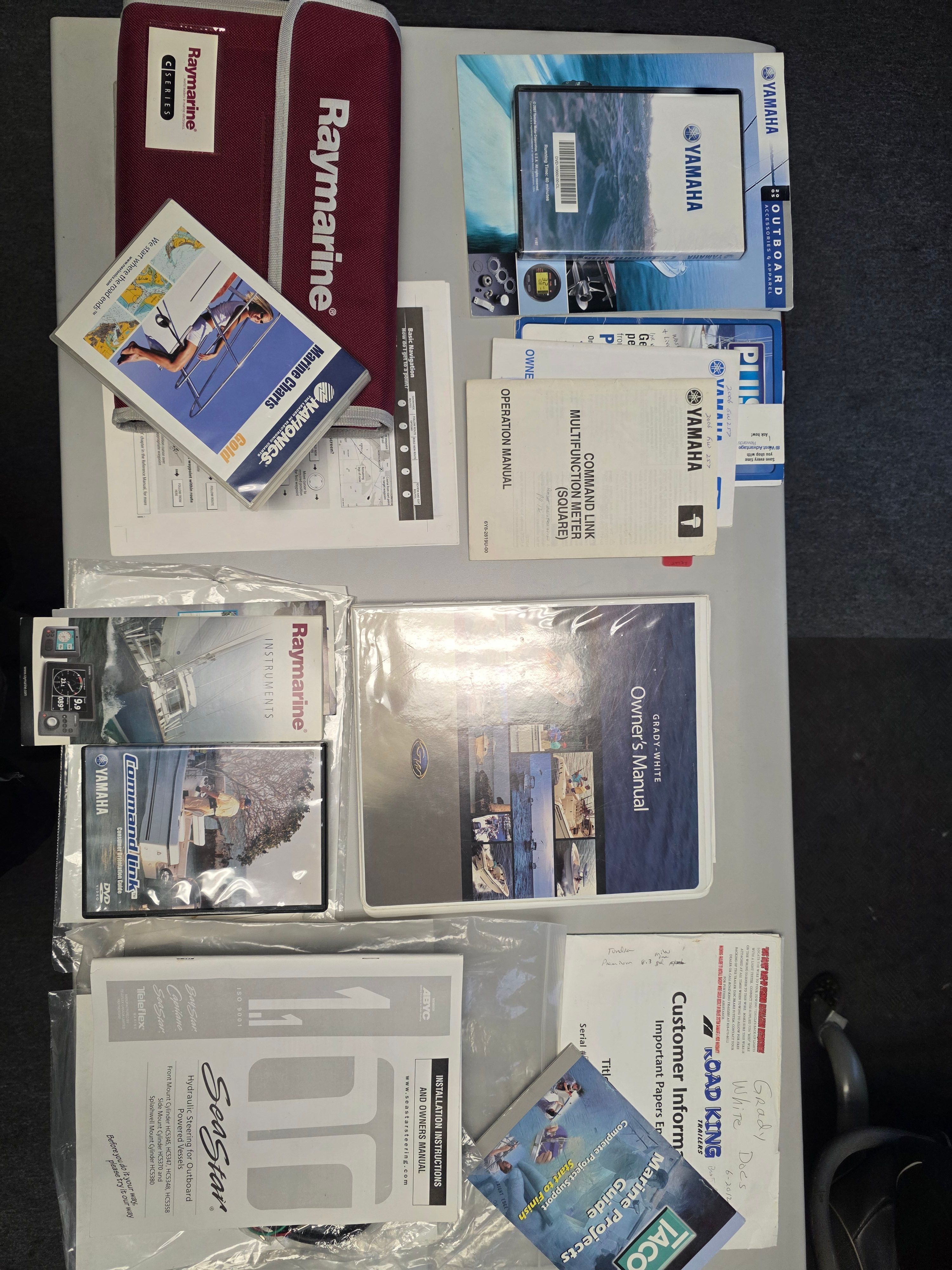 A collection of manuals and brochures for a 2006 Grady-White 257 boat.