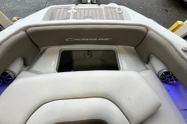 2023 Crownline Eclipse E235 XS boat interior with cushioned seating and storage compartment.