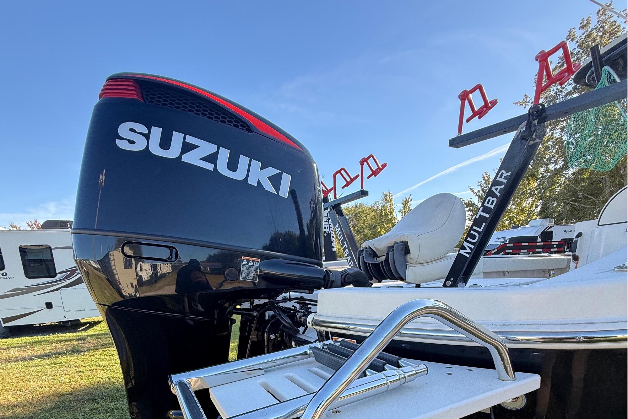 2021 Carolina Skiff 26 Ultra Elite with Suzuki outboard motor and fishing rod holders.