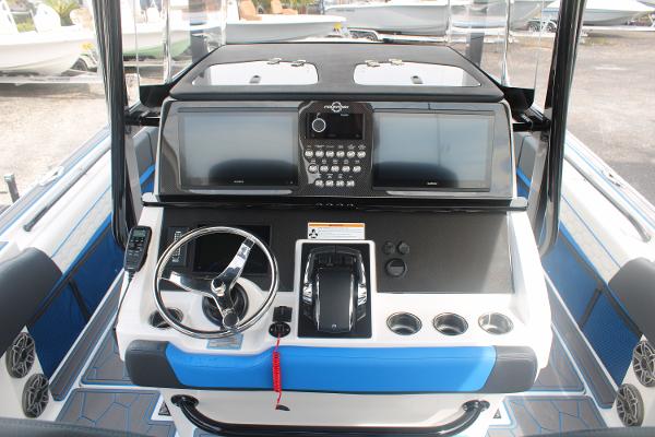 2024 Fountain 34 SC boat dashboard with steering wheel and control panel.