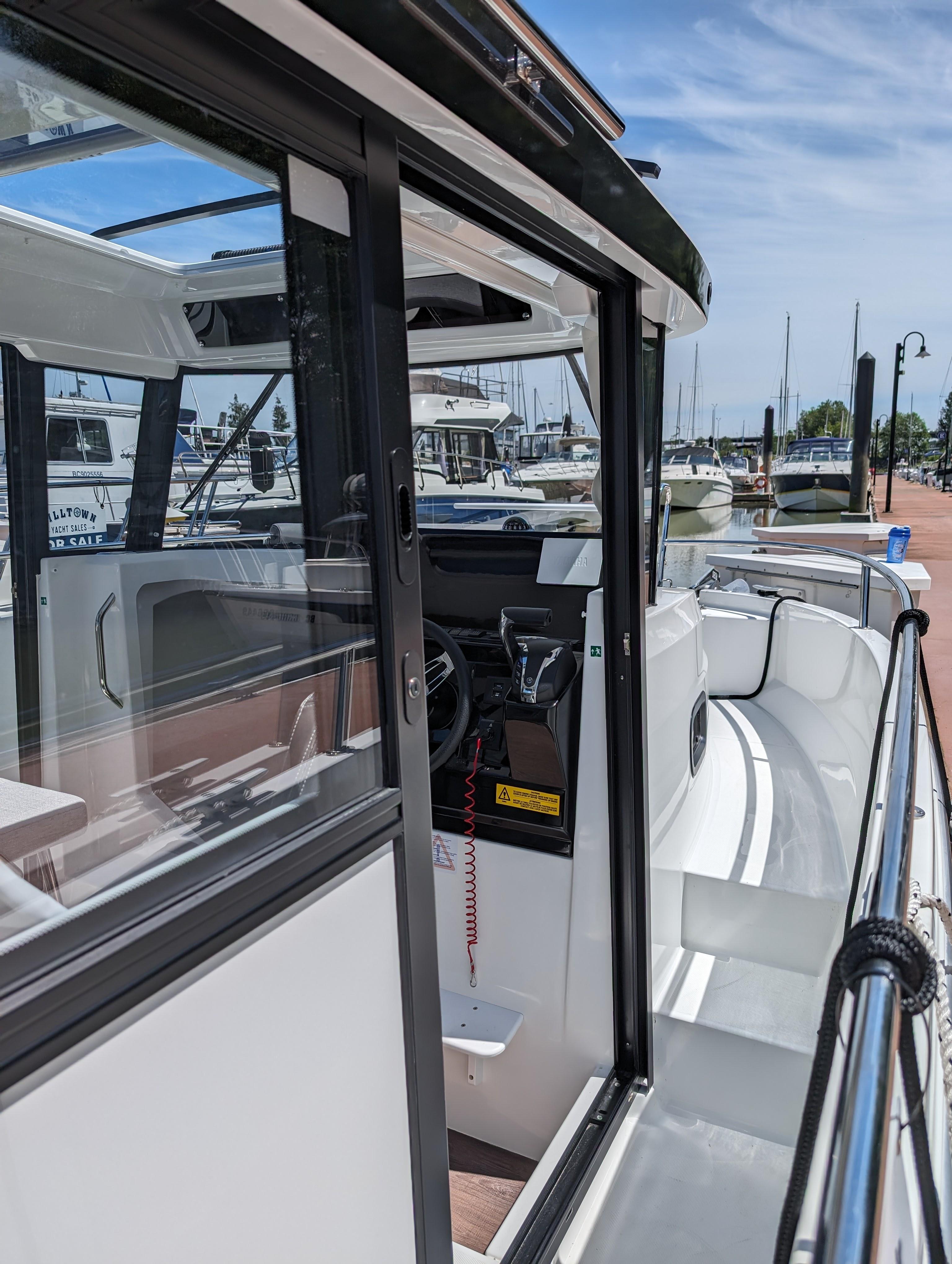 2024 Jeanneau NC Sport 795 Series 2 boat docked at a marina, showcasing sleek design.