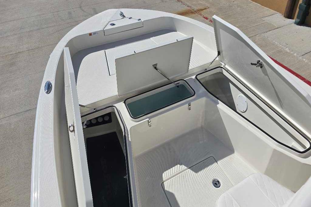 2025 Ranger 2360 Bay boat with open storage compartments on deck.