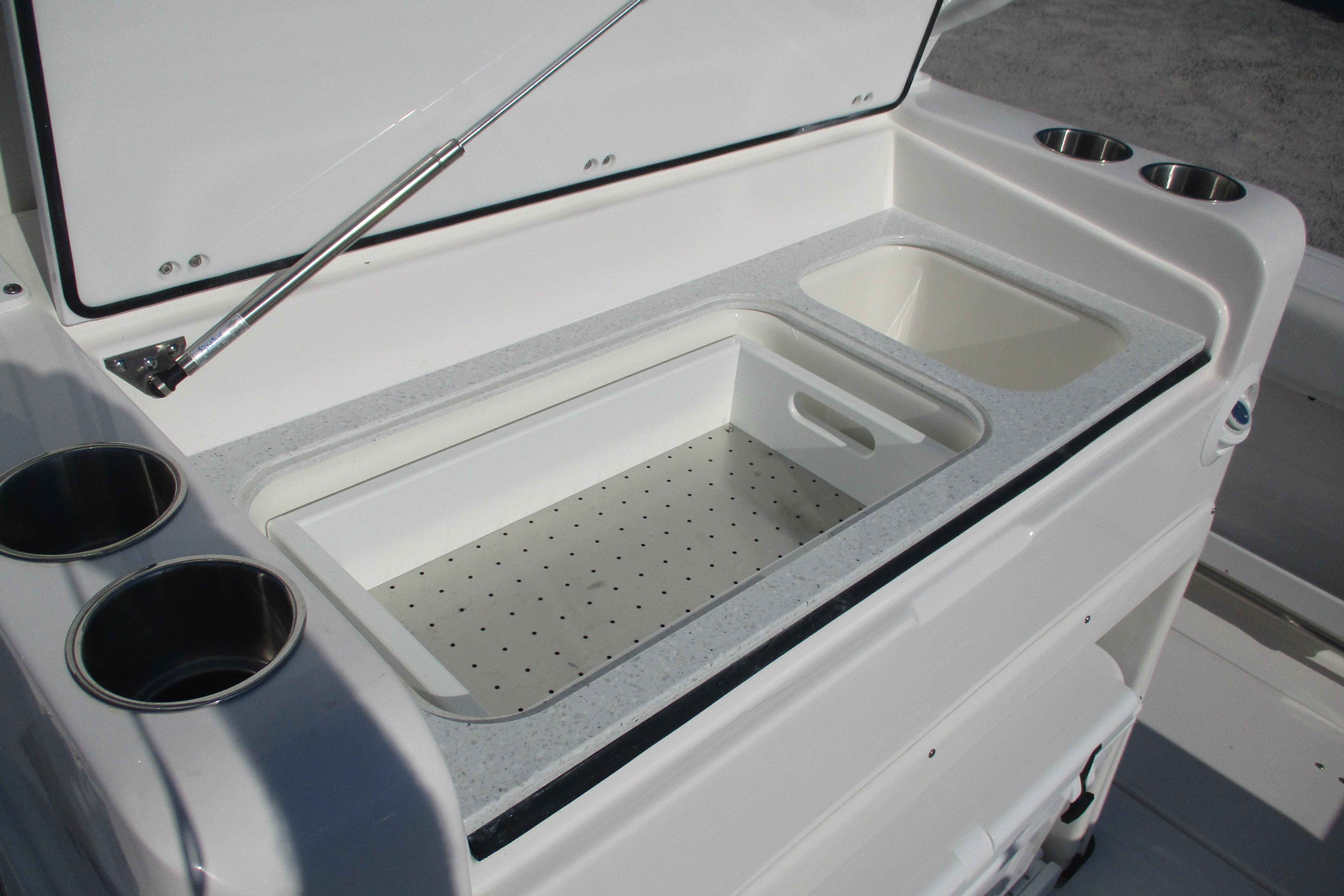 2026 Sea Fox 328 Commander boat with open storage compartment and cup holders.
