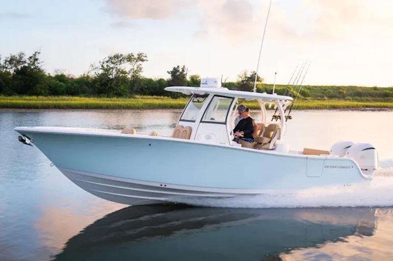 2026 Sportsman Open 282 Center Console boat cruising on a calm waterway.