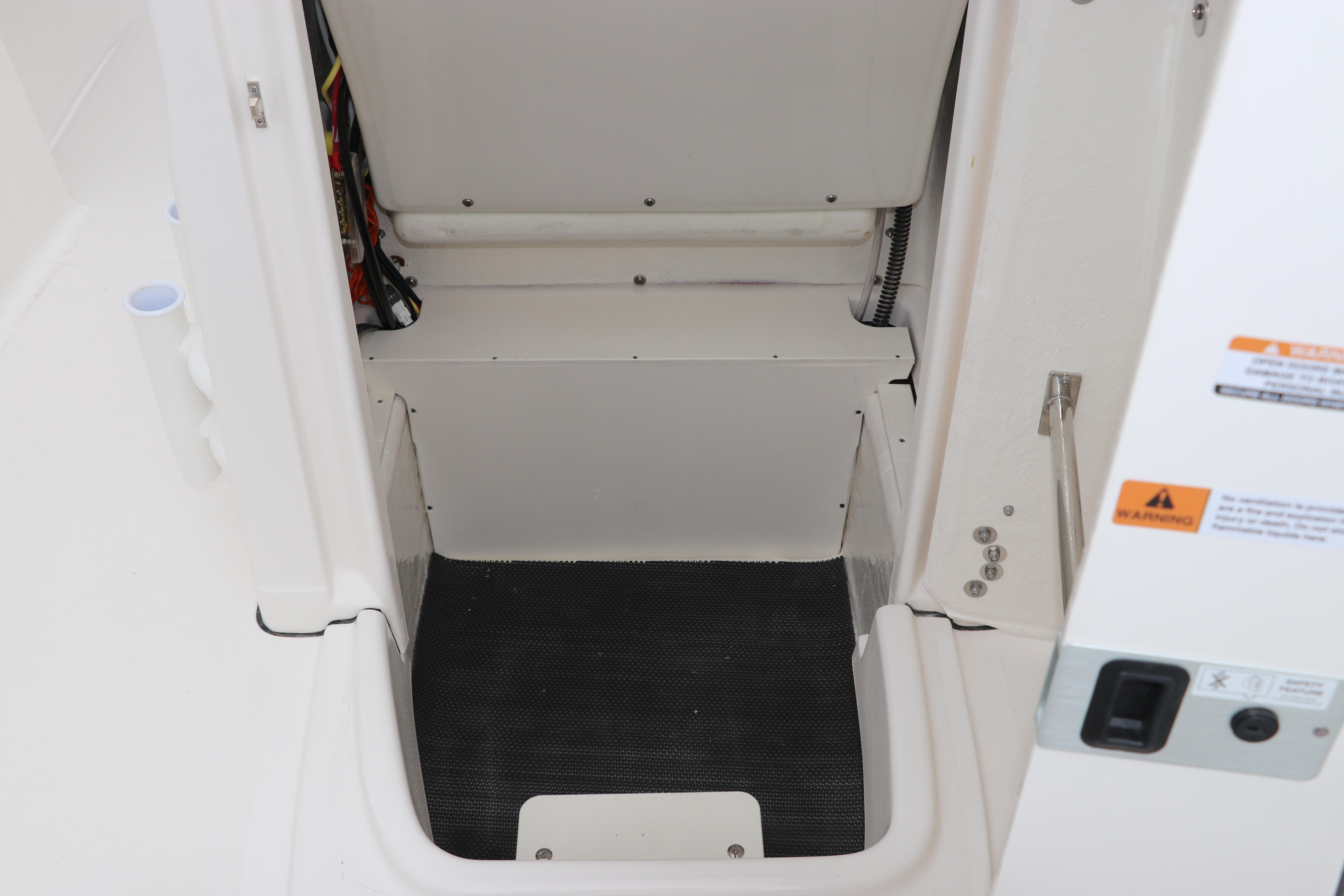2026 Robalo R180 Center Console interior storage compartment with safety warnings.