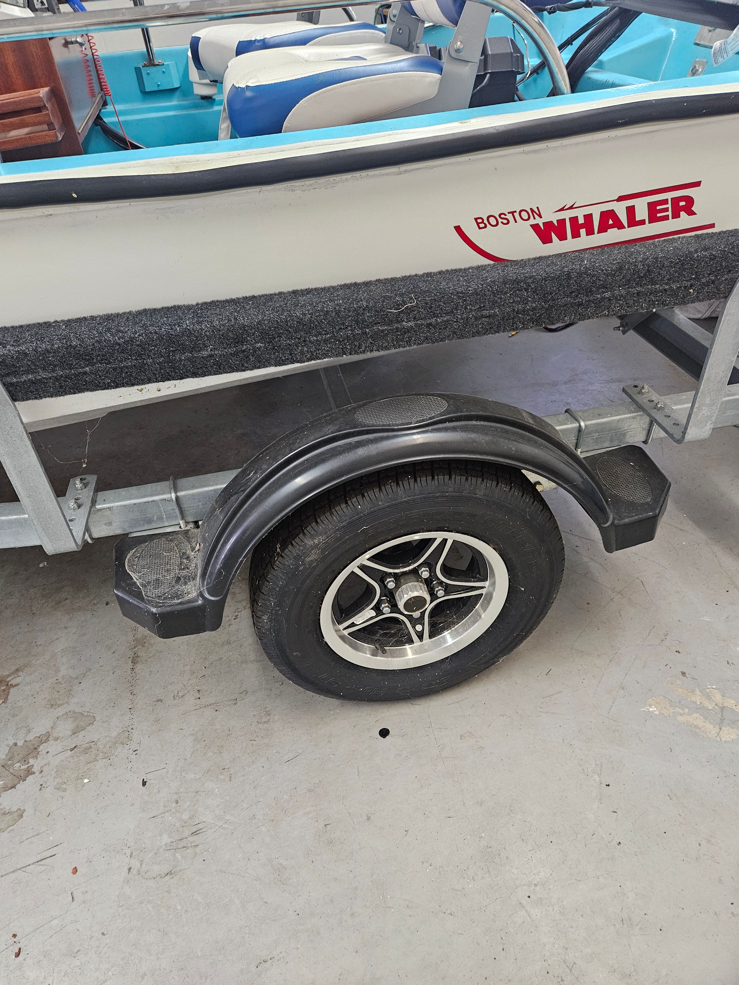 1977 Boston Whaler 14 boat on trailer indoors.