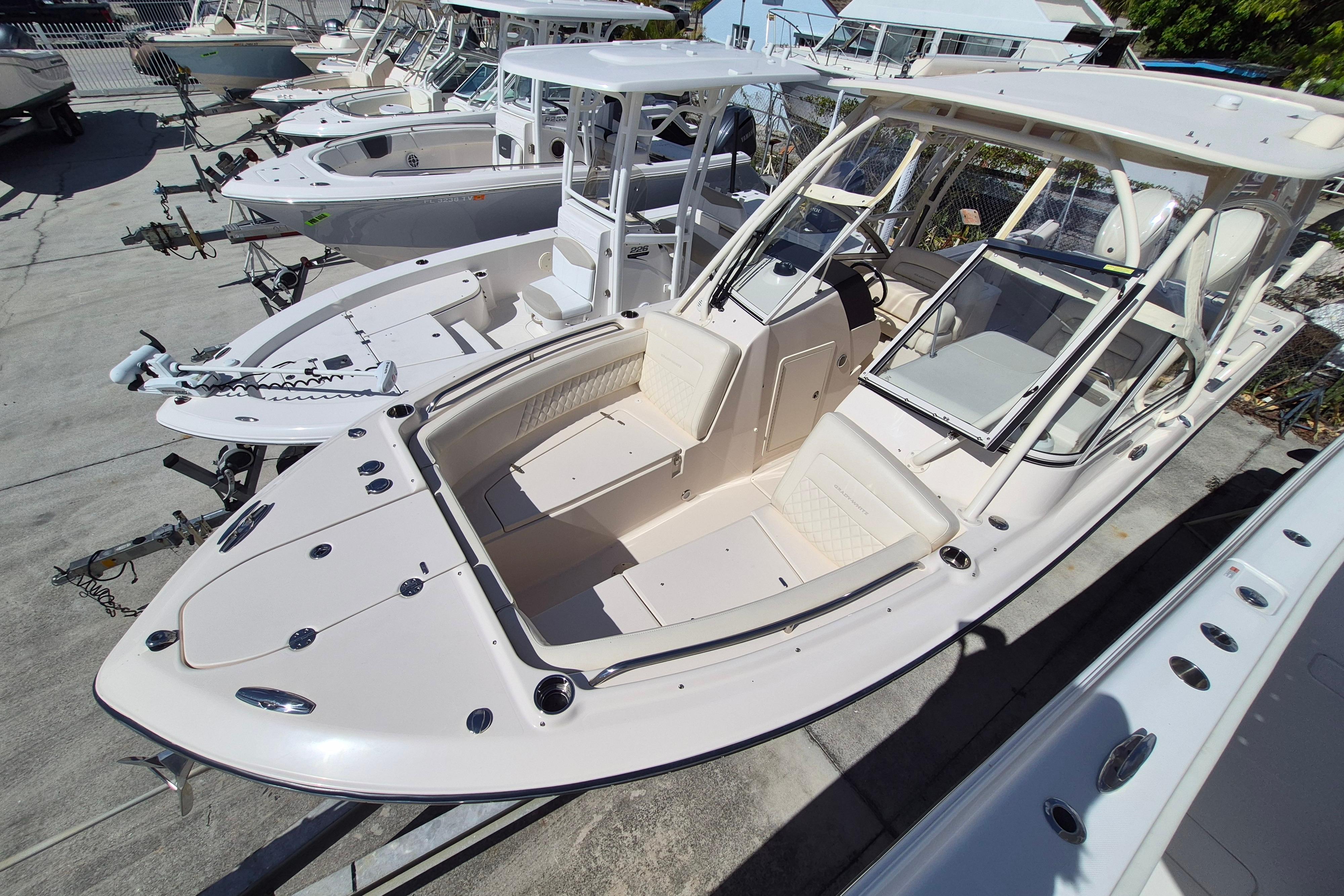 2025 Grady-White Freedom 275 boat displayed in a marina, showcasing sleek design and spacious seating.