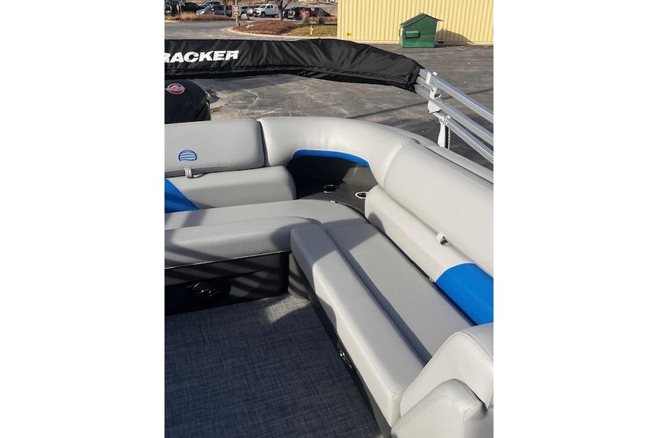 2026 Sun Tracker Party Barge 20 DLX with gray and blue seating on deck.