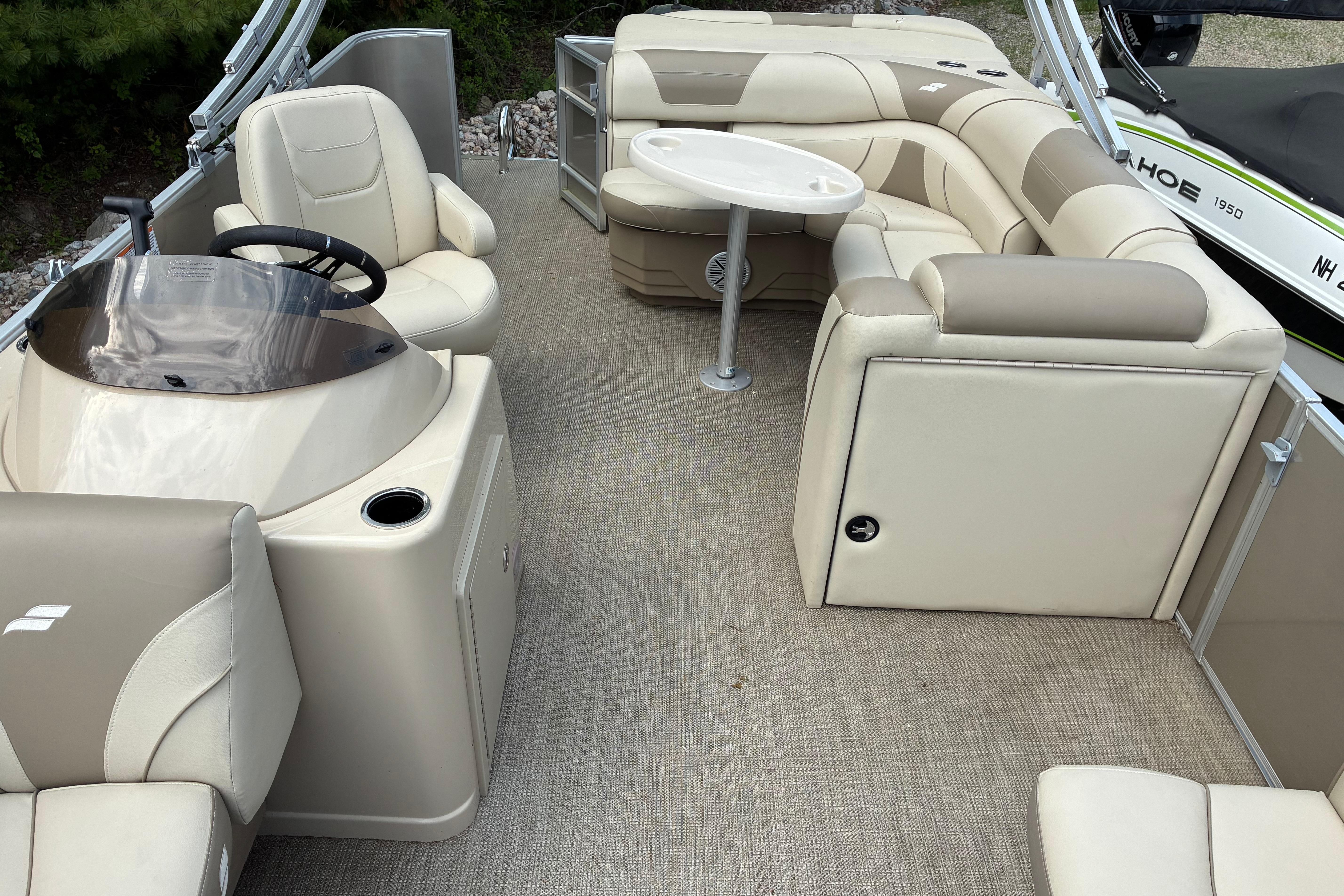 2020 Starcraft EX 20 C pontoon boat interior with beige seating and steering console.