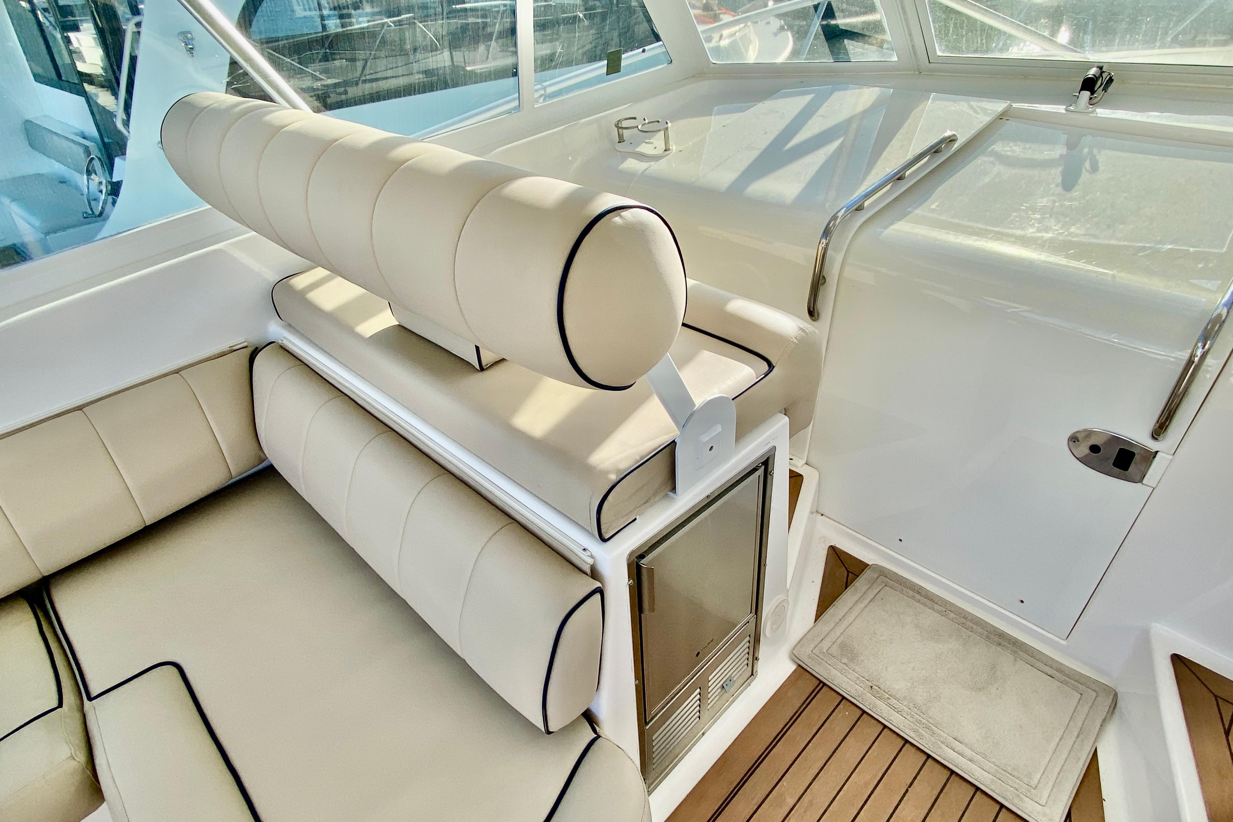2006 Luhrs 41 Open boat interior with beige seating and wooden flooring.