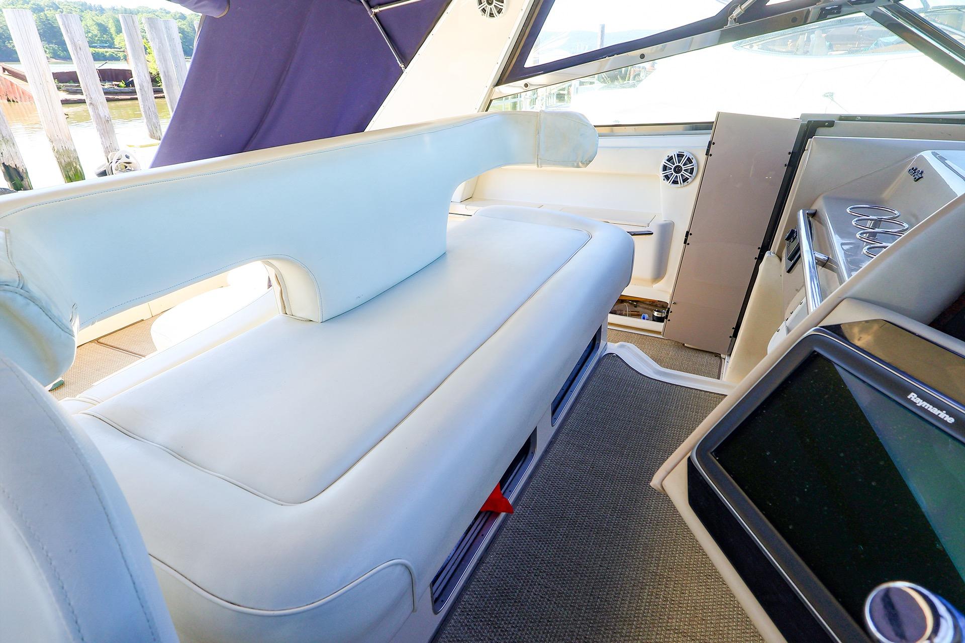 Interior of 1998 Sea Ray 500 Sundancer yacht, featuring plush seating and modern controls.