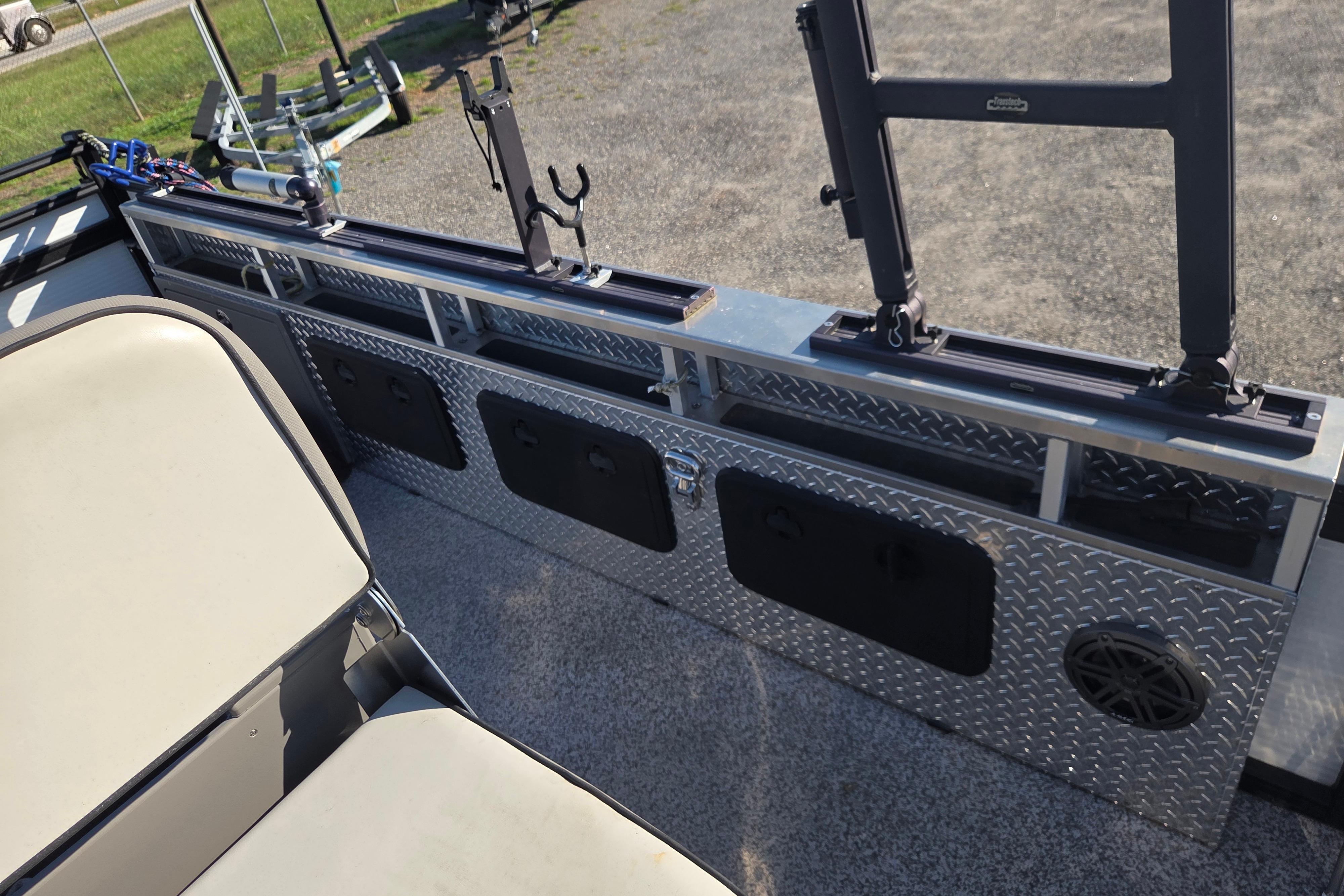 2024 Angler Qwest 8526 Pro Troll boat interior with fishing rod holders and storage compartments.