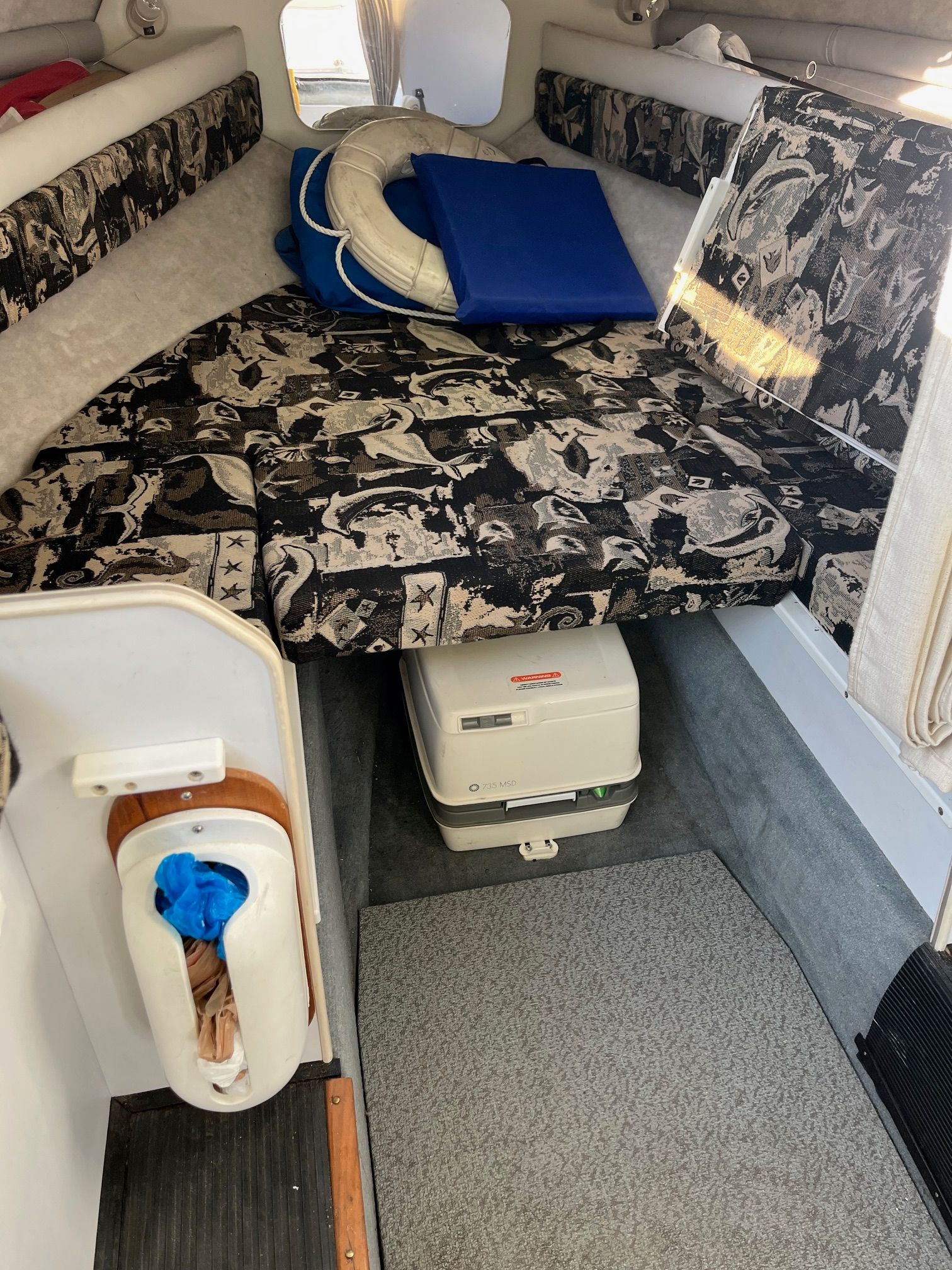 Interior of a 2002 Campion 622 Explorer with a sleeping area and portable toilet.