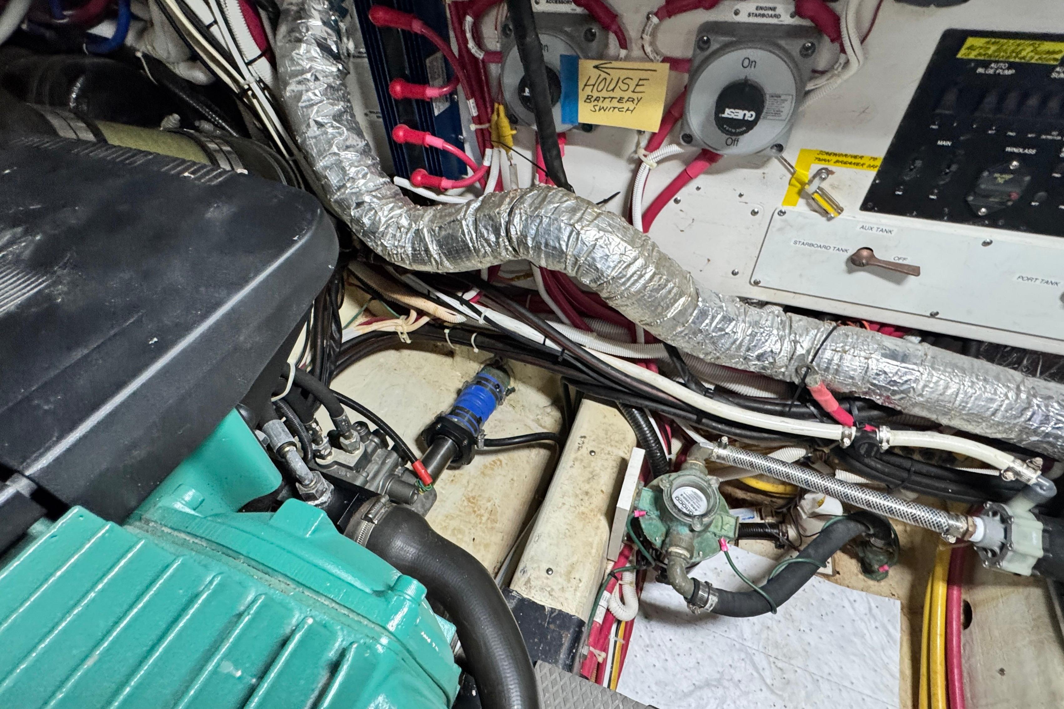 Engine room of a 2007 Carver 47 Motor Yacht, showing wiring and mechanical components.