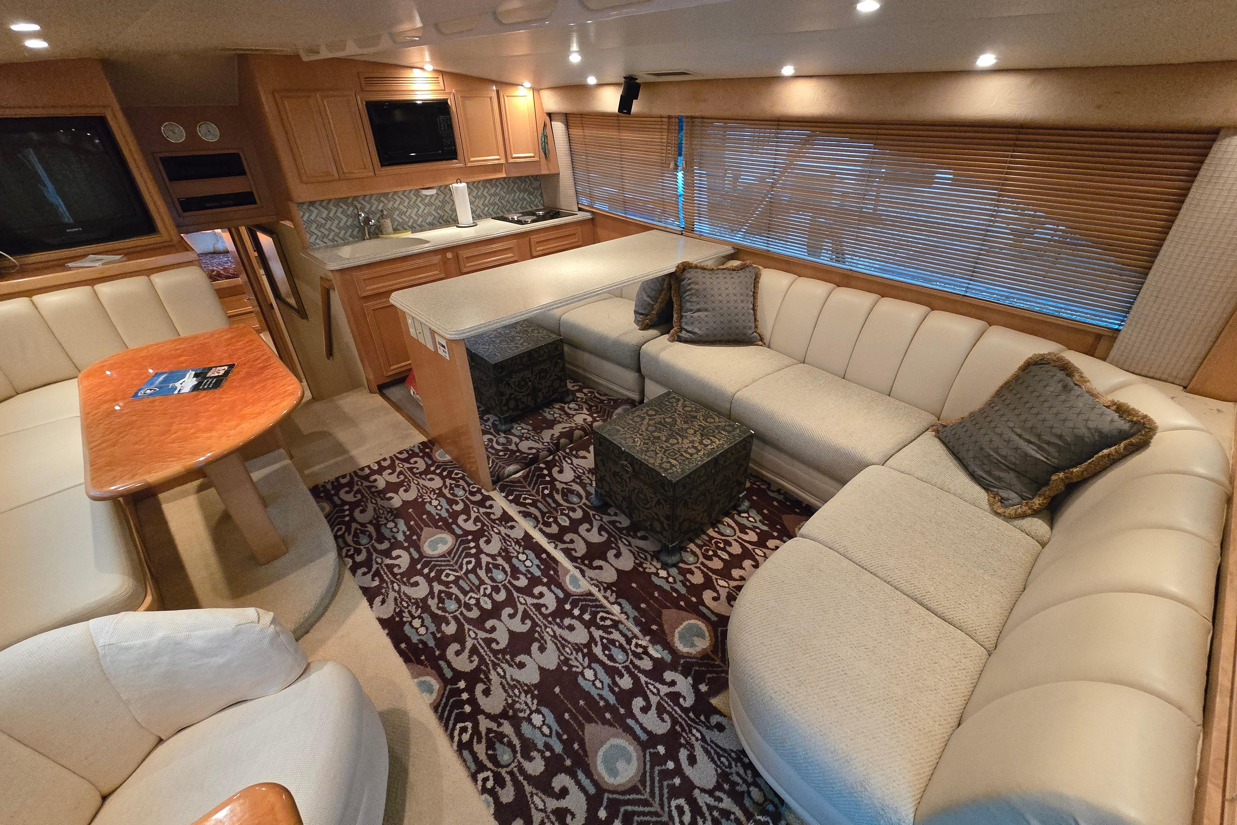 Luxurious interior of a 2001 Cavileer 53 Convertible yacht with plush seating and elegant decor.