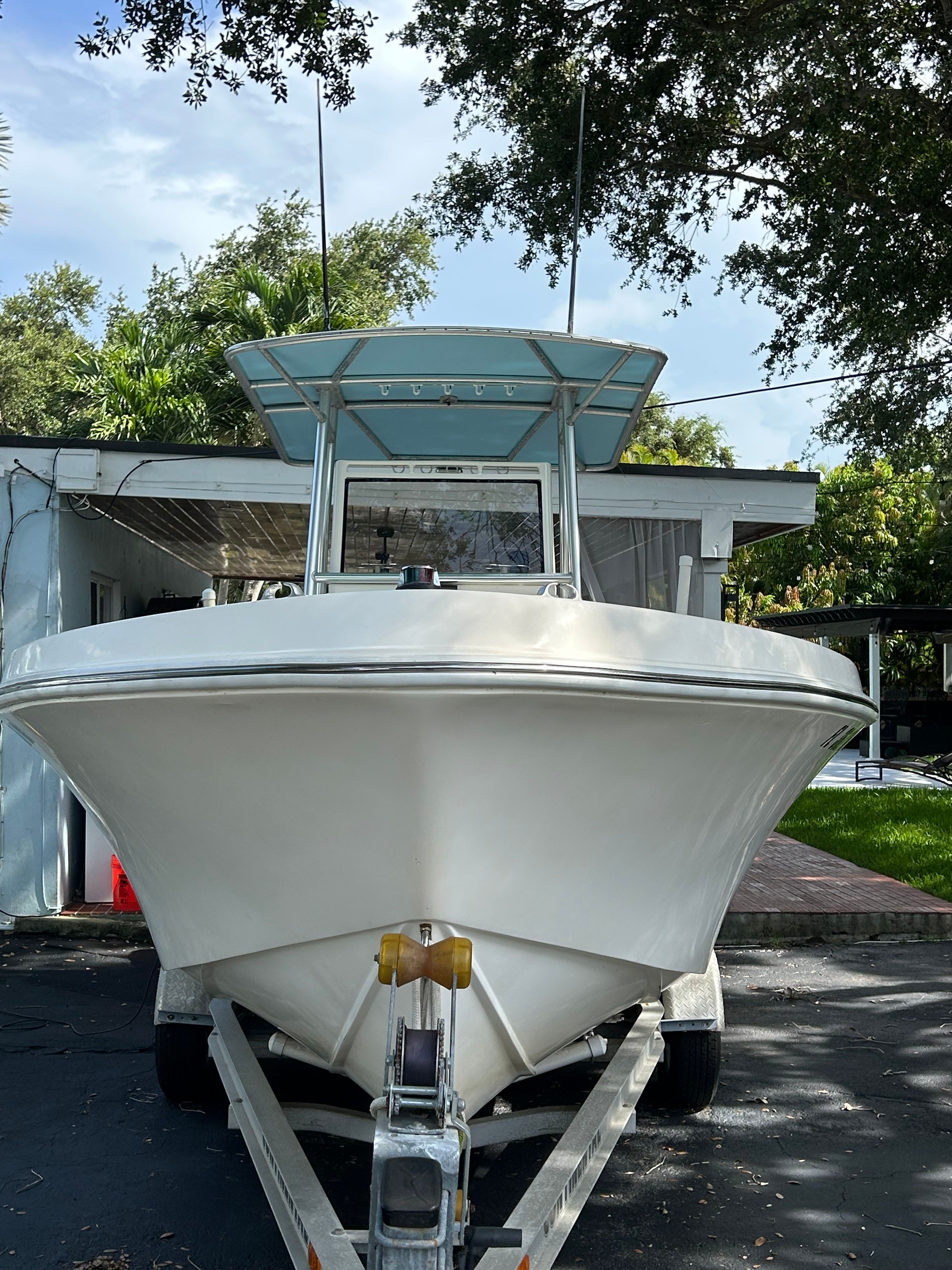 1992 Mako 221 boat on trailer in front of garage.
