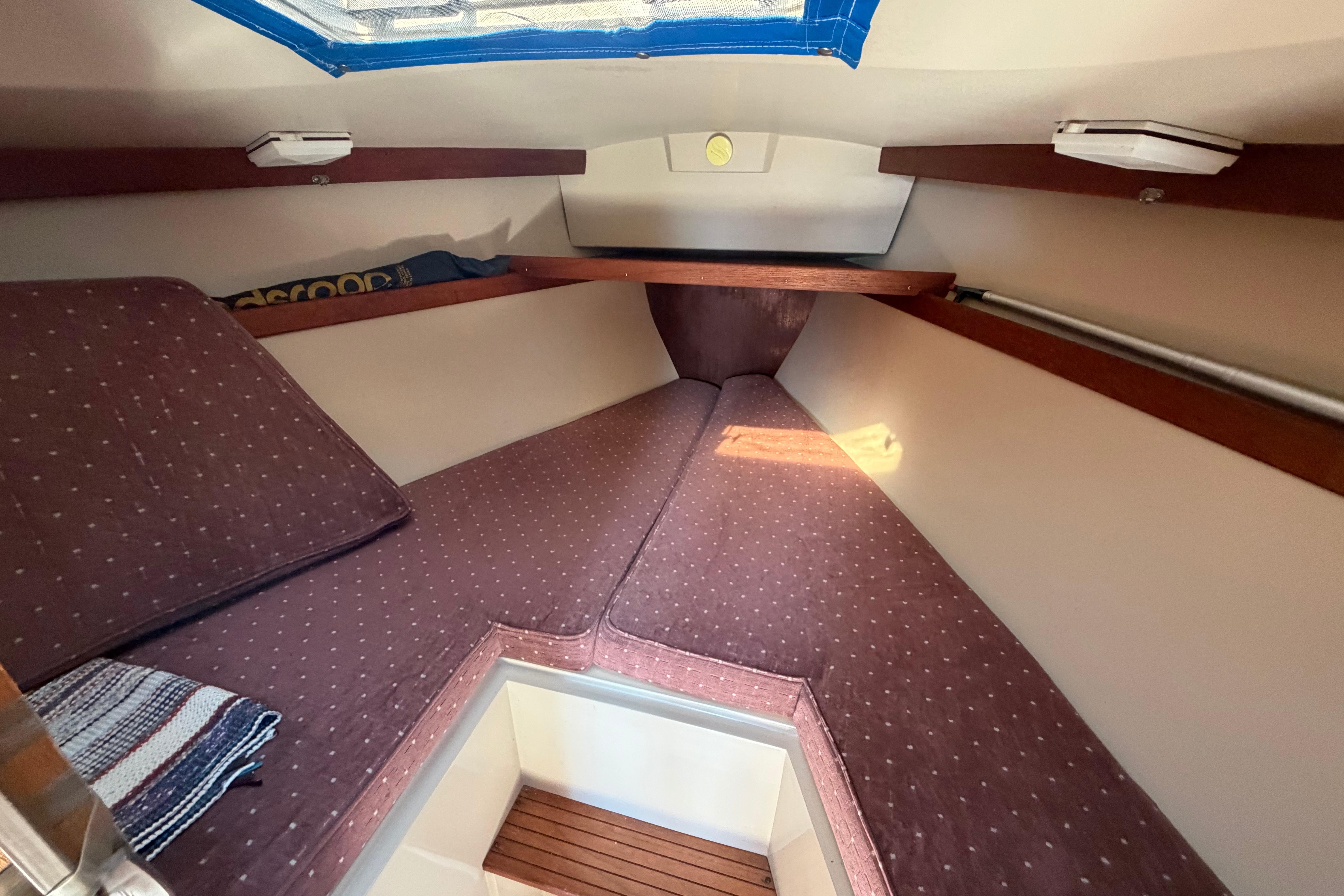 Interior cabin of 1988 Catalina 30 MkII sailboat with cozy V-berth and cushions.