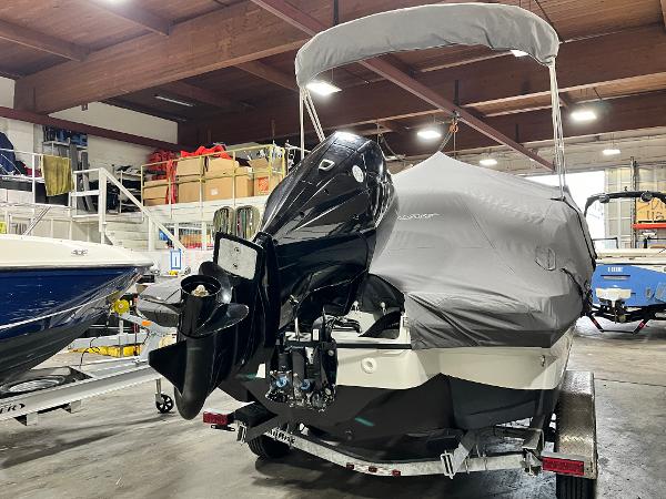 2023 Crownline Eclipse E235 XS boat covered in a garage setting.
