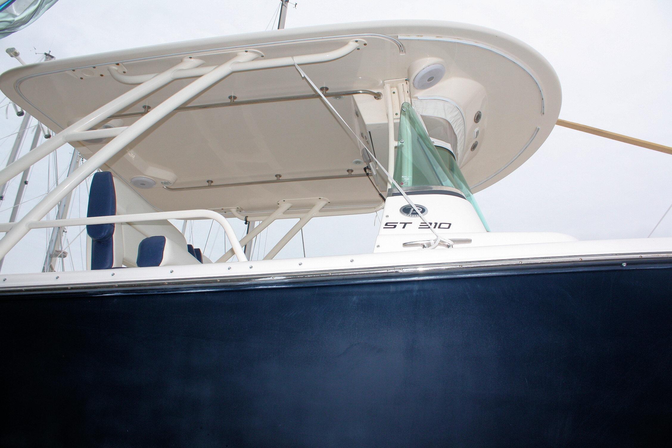 2013 Pursuit ST 310 Sport boat, side view with canopy and seating.