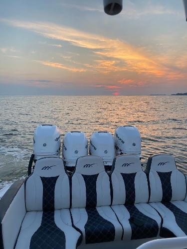 2019 Midnight Express 39 Cuddy boat at sunset on the ocean.