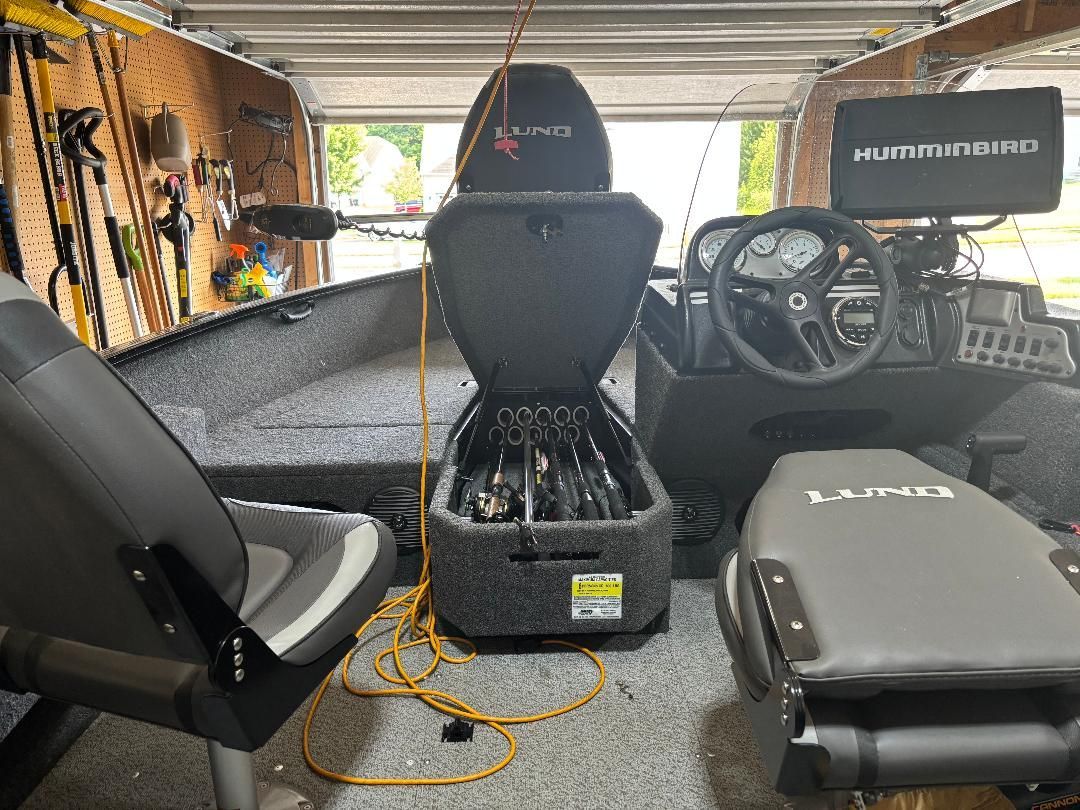 Interior of a Lund Advent boat with seating and fishing rod holders.