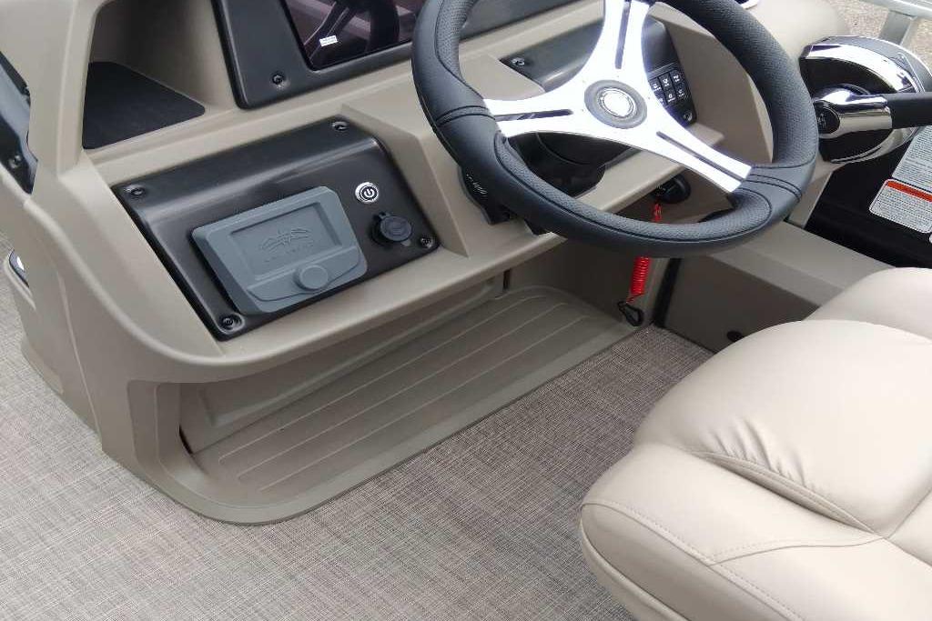 2025 Sun Tracker Sportfish 24 XP3 boat interior with steering wheel and control panel.
