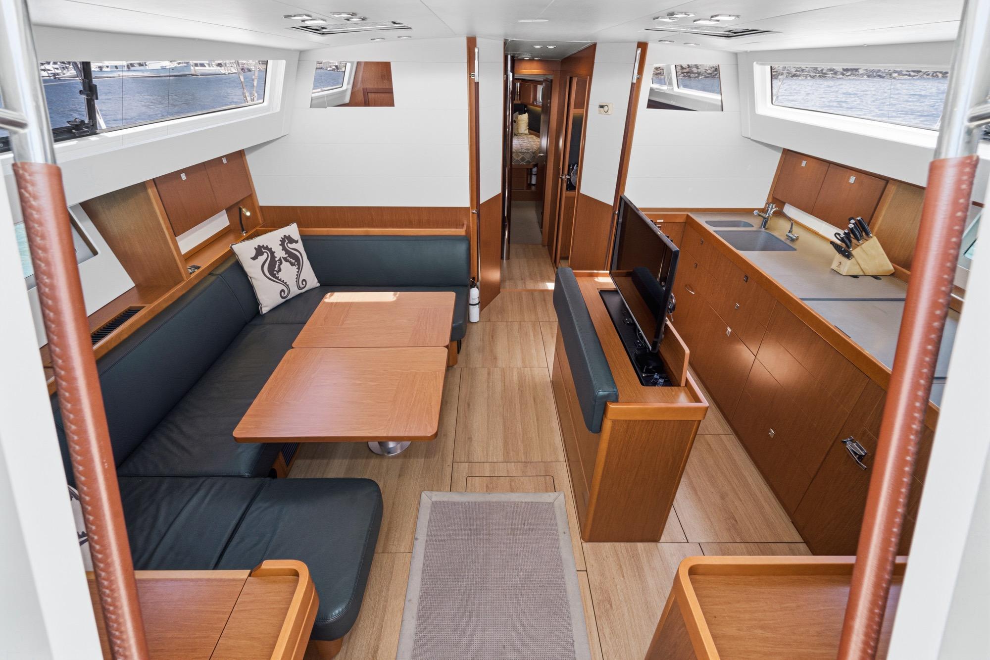 Luxurious interior of 2017 Beneteau Sense 50 yacht with modern kitchen and seating area.