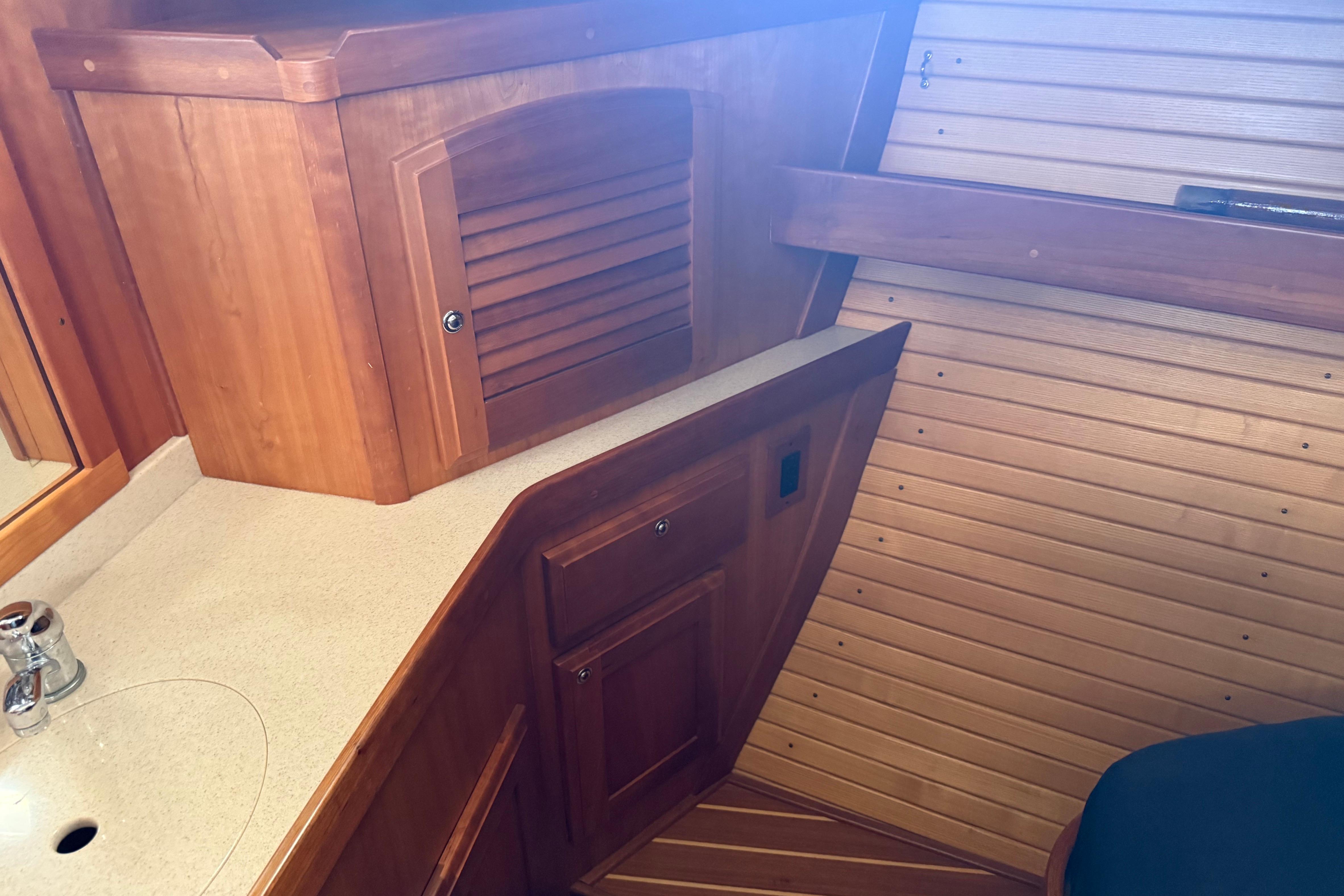 2004 Sabre 386 yacht interior with wooden cabinetry and countertop.