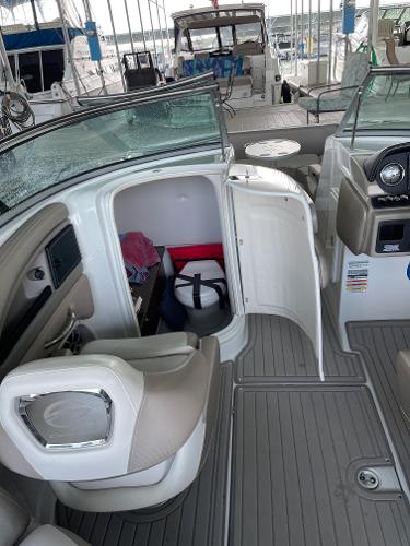 2019 Crownline E255 boat interior with open storage compartment and seating area.
