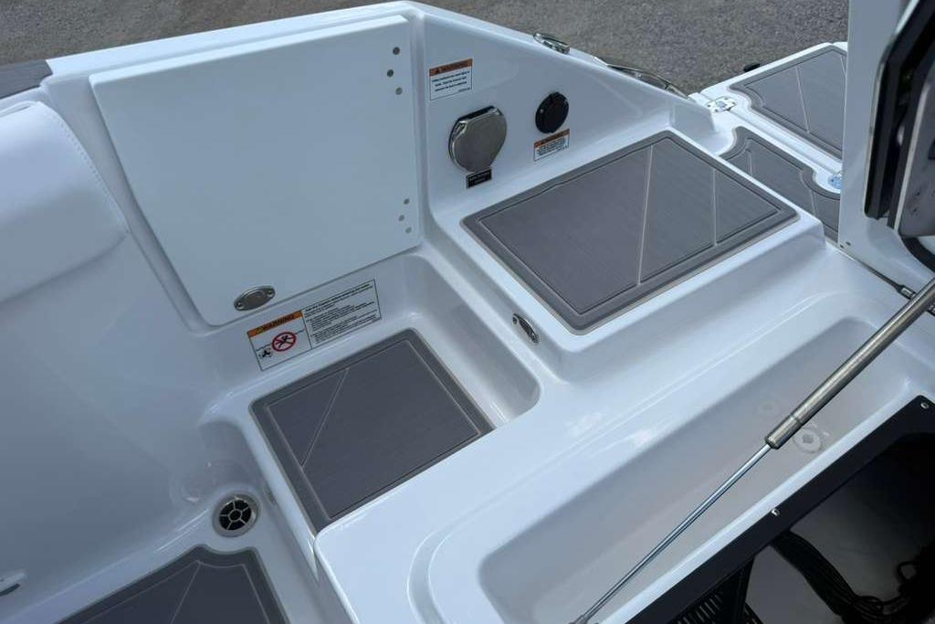 2026 Monterey Elite 30 OB boat deck with storage compartments and sleek design.